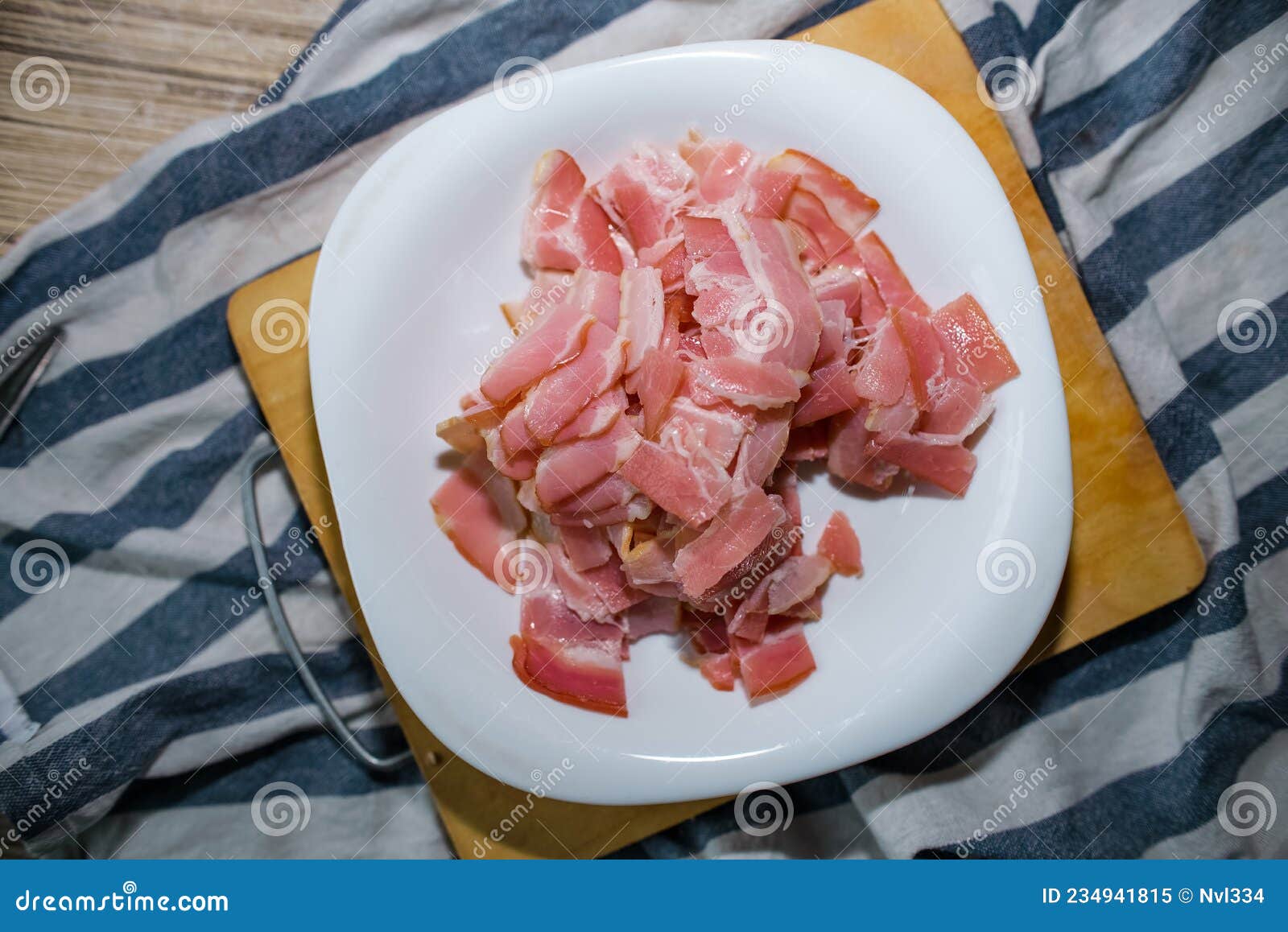Top View Chopped Chopped Bacon Lying on a Plate in the Kitchen, Indoors