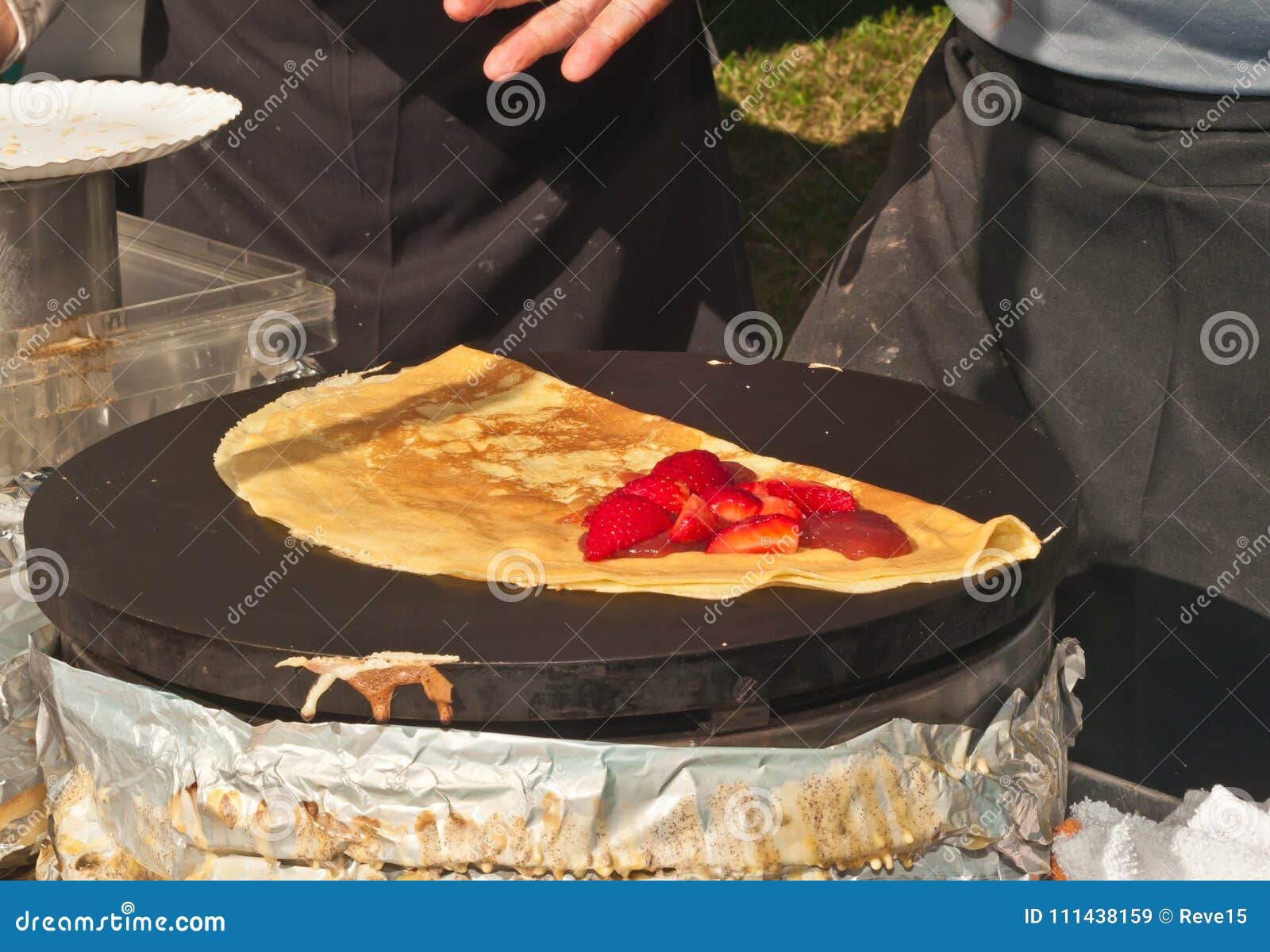 top view of a vender preparing a strawberry crepe