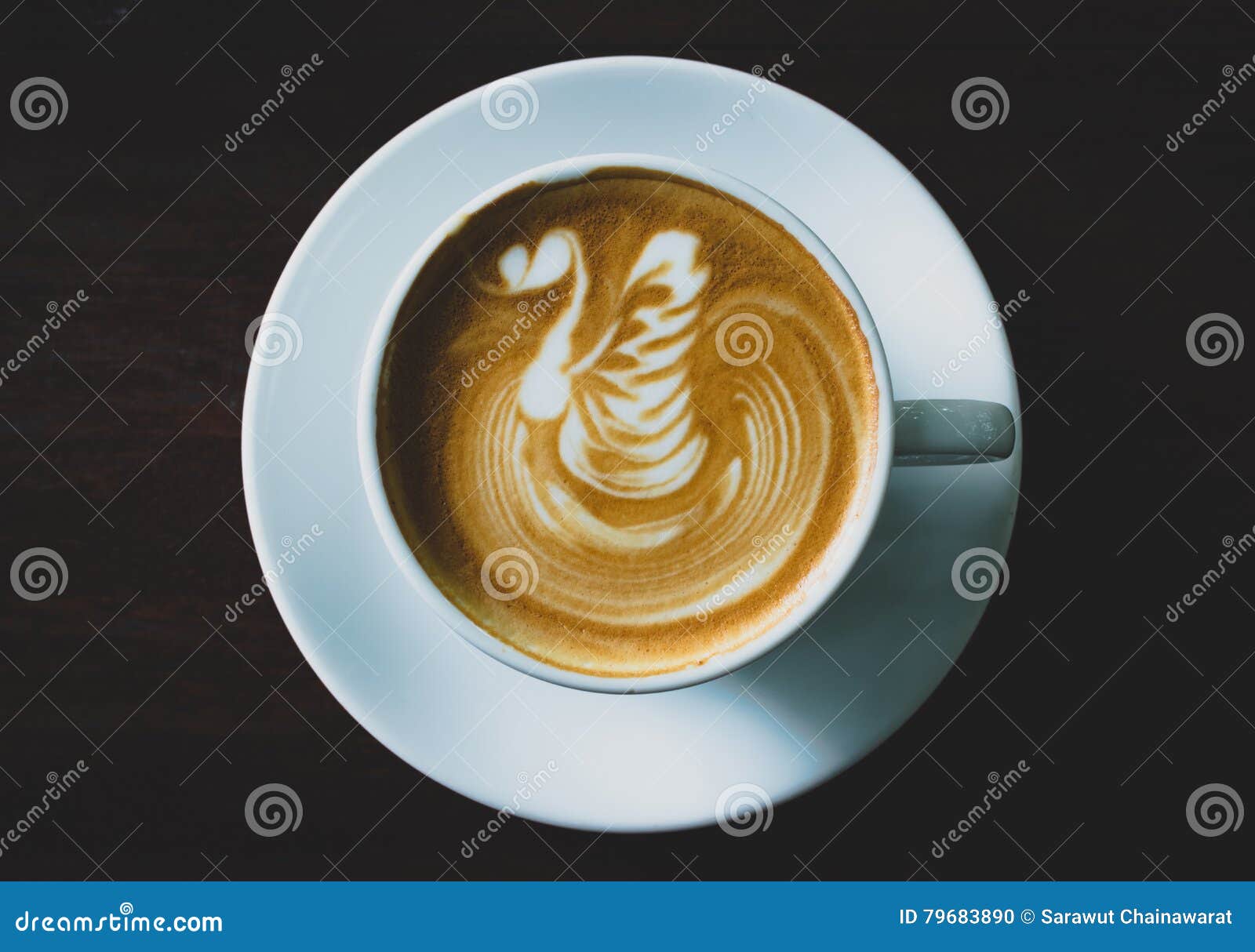 Top View Coffee Cup Latte Art on Wood Table Dark Tone. Stock Photo