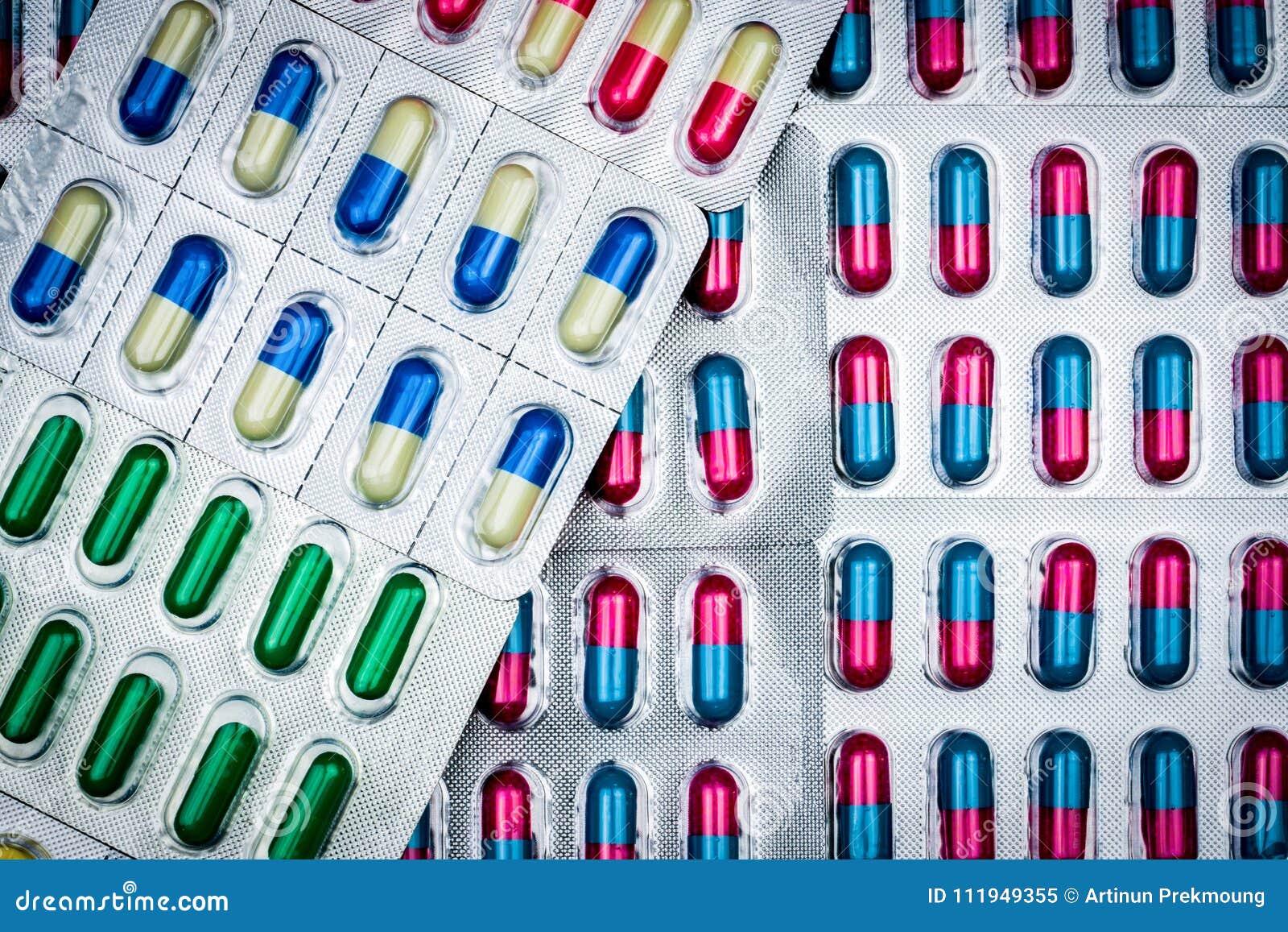 top view of colorful tablets and capsules pills in blister packs.