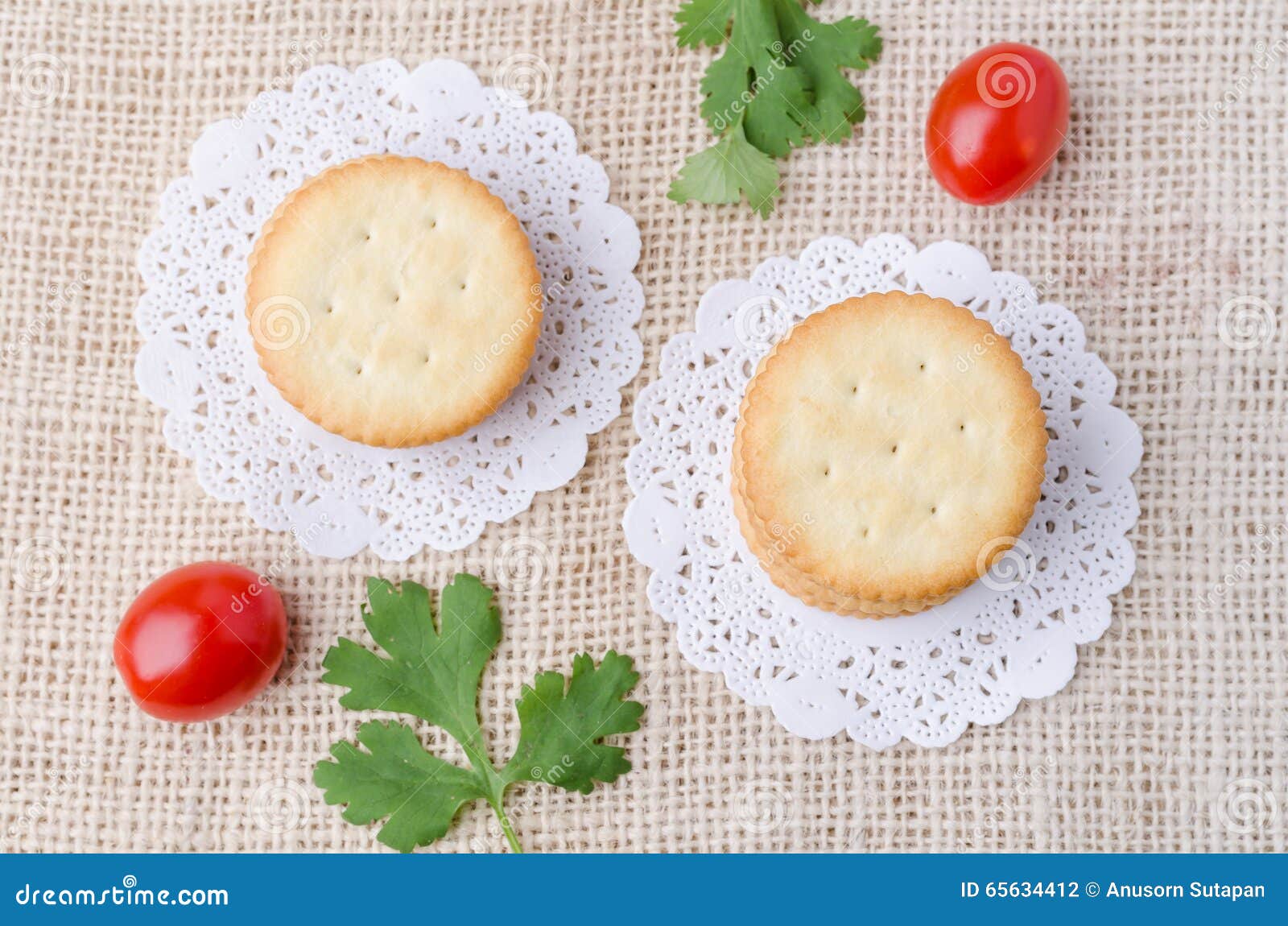 Top View of Crackers Biscuits on Burlap Sack Background Stock Photo