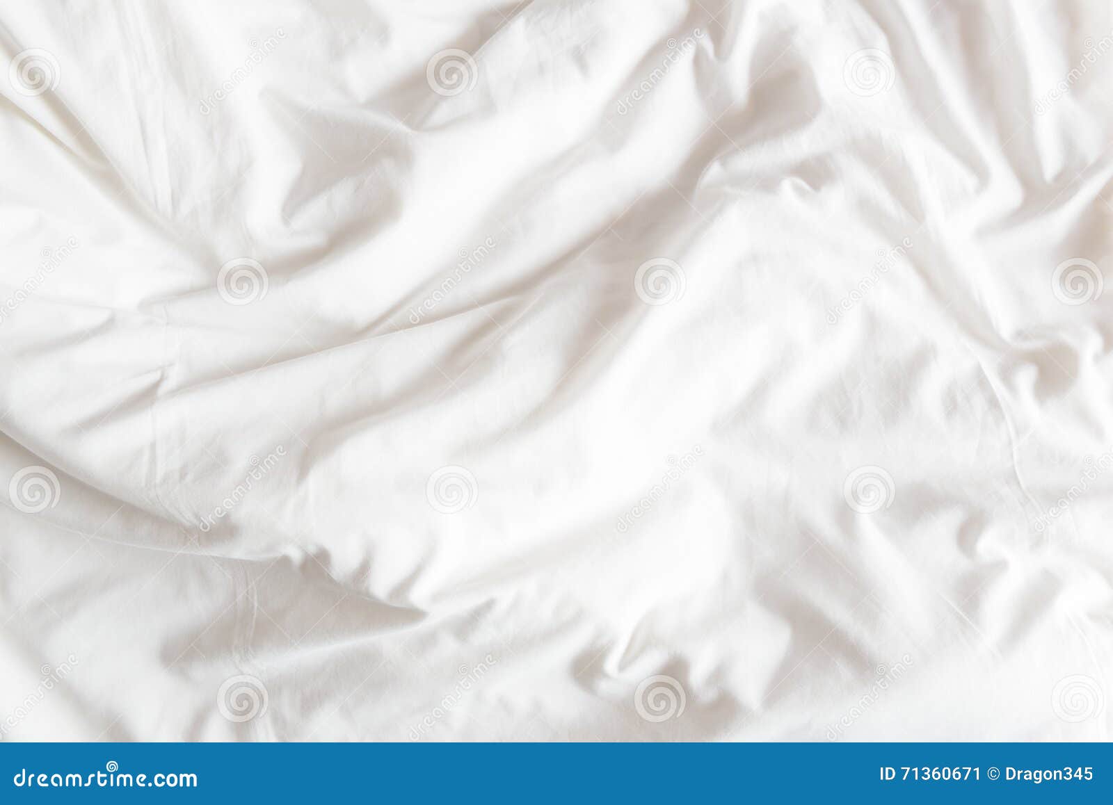 top view of the crease of an unmade bed sheet in the bedroom.