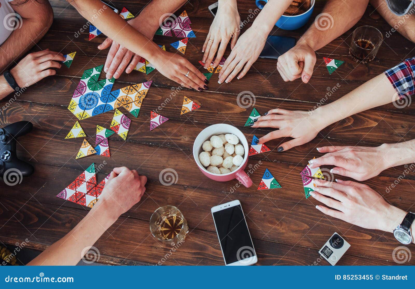 Top View Creative Photo Of Friends Sitting At Wooden Table Having Fun