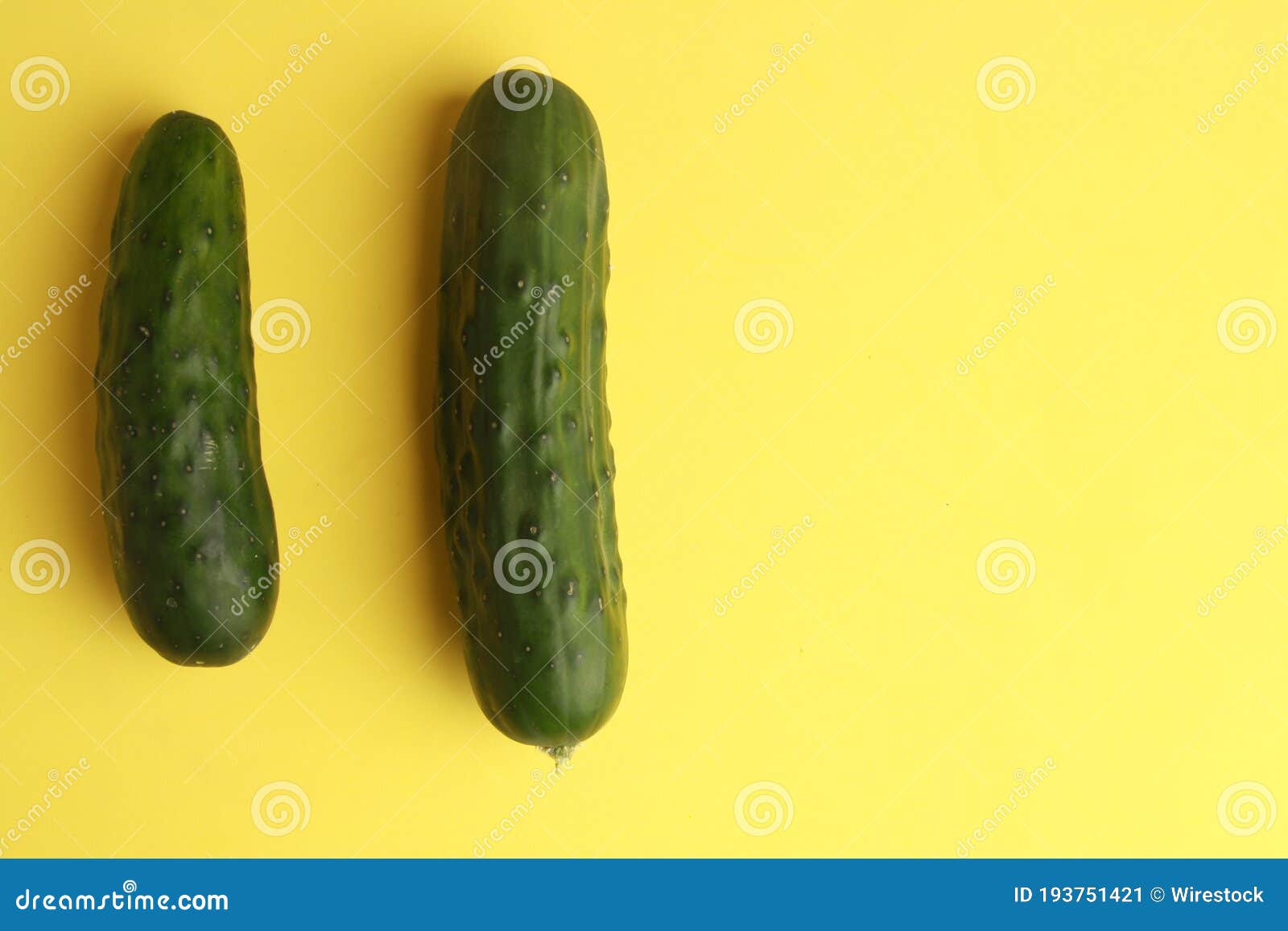 Top View of Cucumbers Under the Lights on a Yellow Surface Stock Image