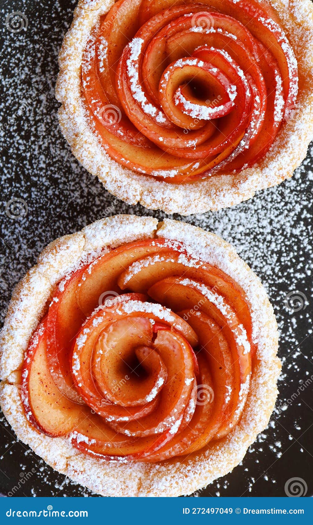 Top View of Mini Apple Rose Tartlets Sprinkled with Powder Sugar Stock