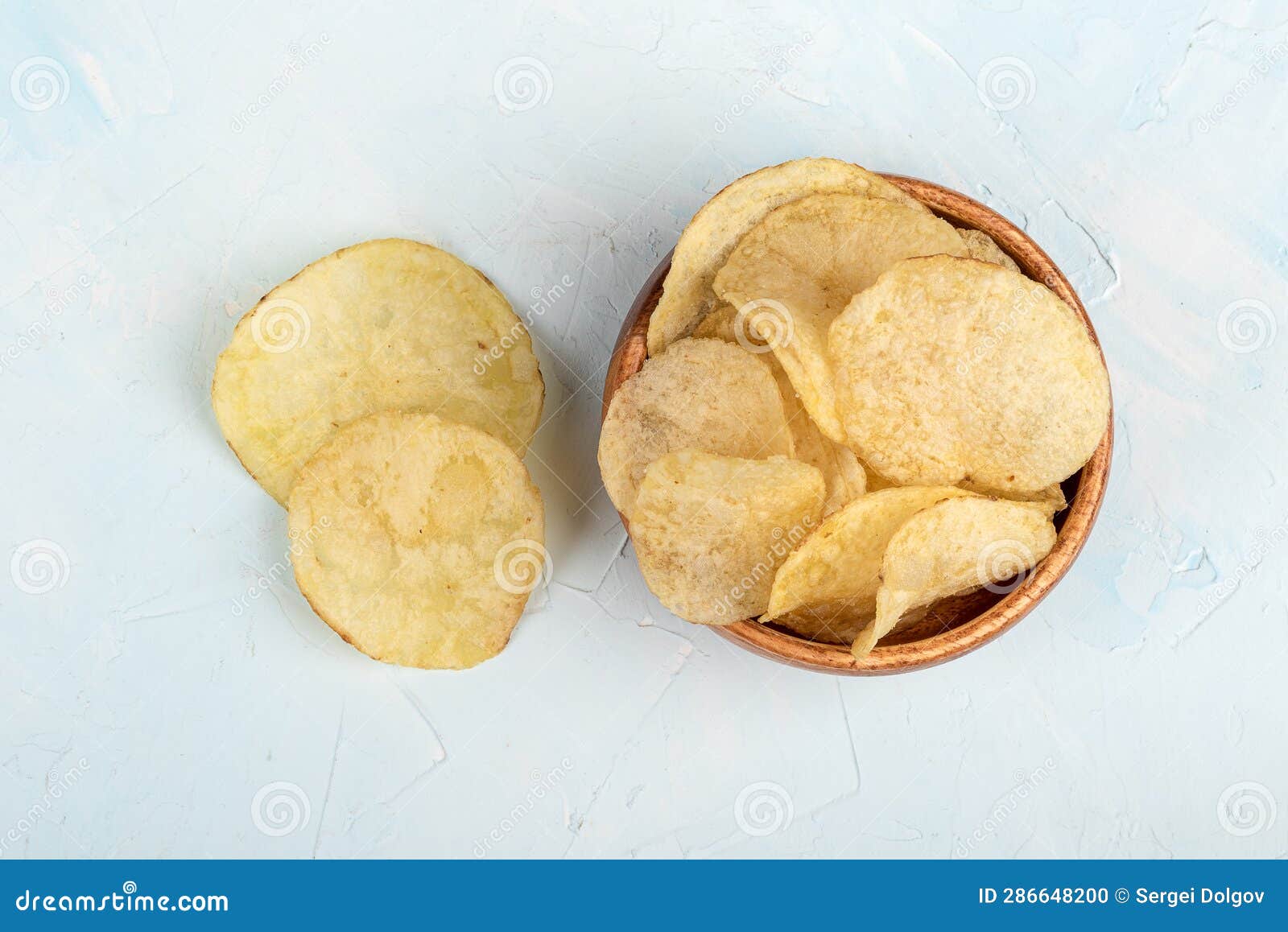 Top View Of Delicious Crispy Potato Chips On Blue Background. Stock ...