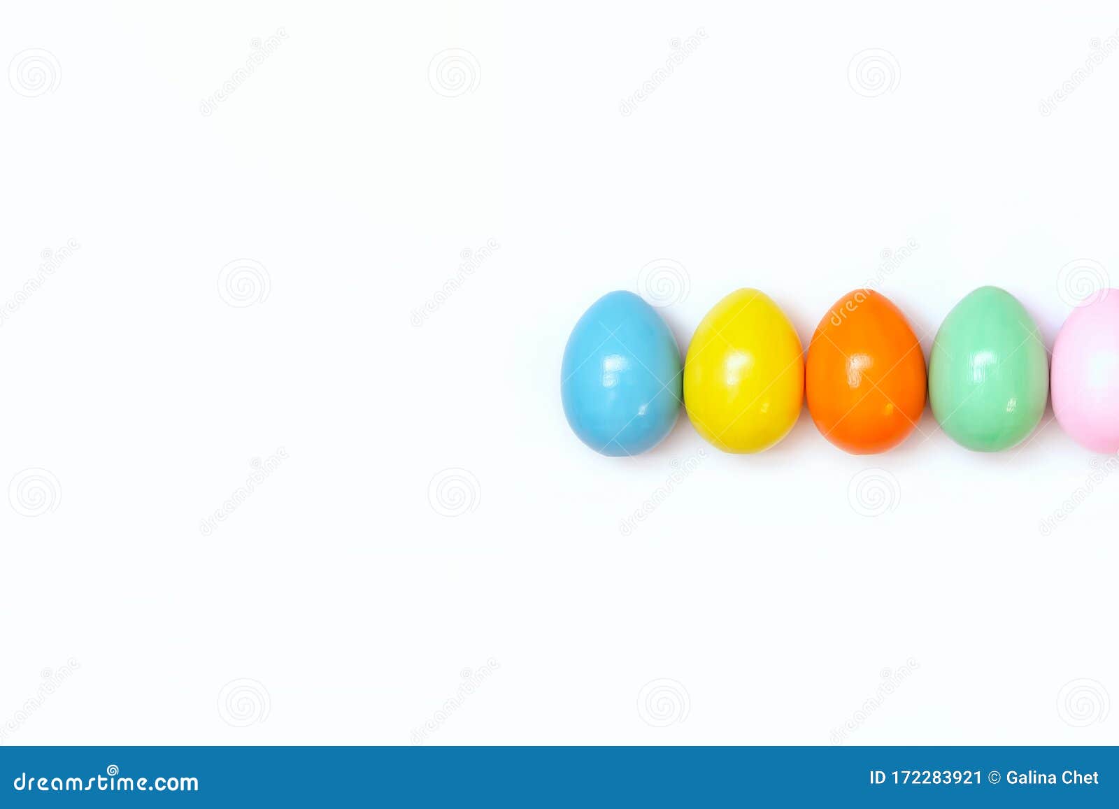 Top View of an Easter Composition of Painted Eggs in Bright Juicy Colors on a White Background