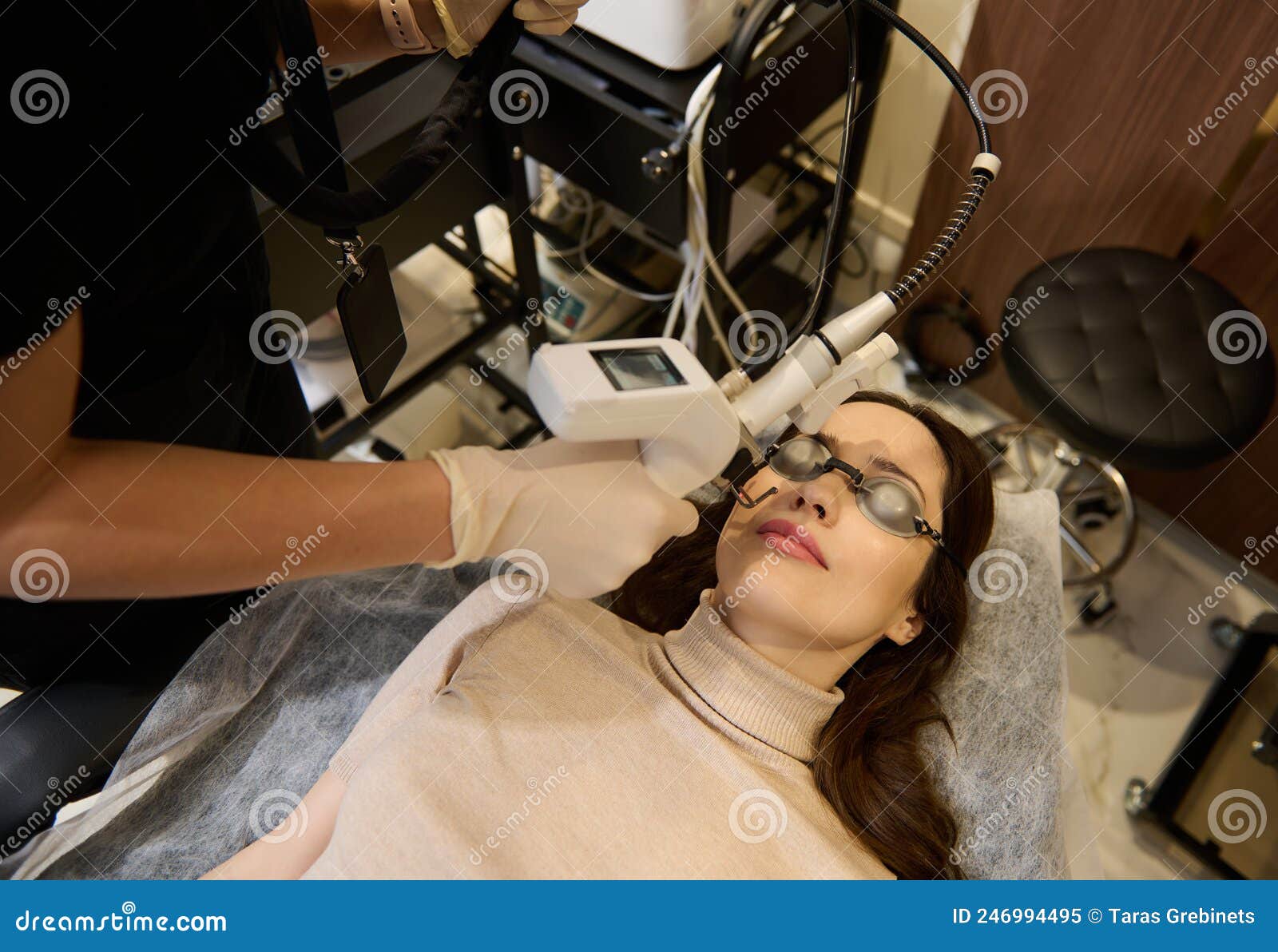 Top View Of European Woman Getting Facial Laser Polishing And