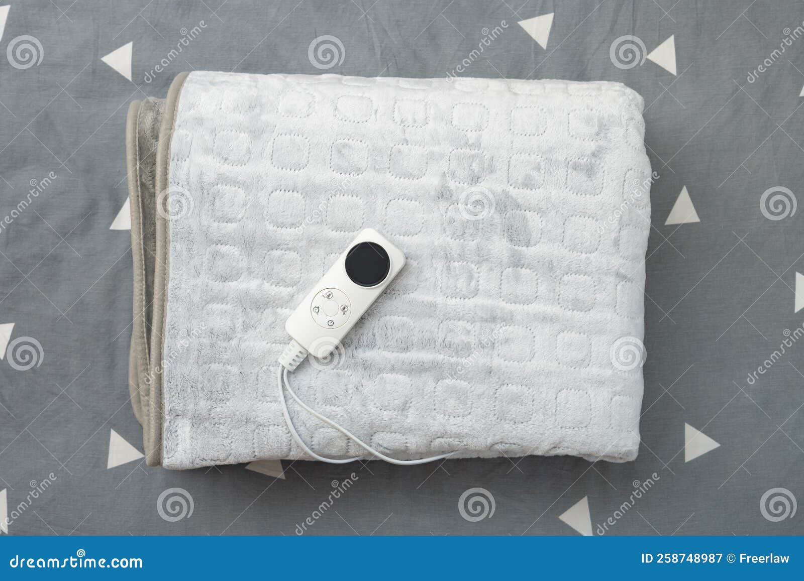 Folded Electric Blanket with Controller on the Bed at Horizontal