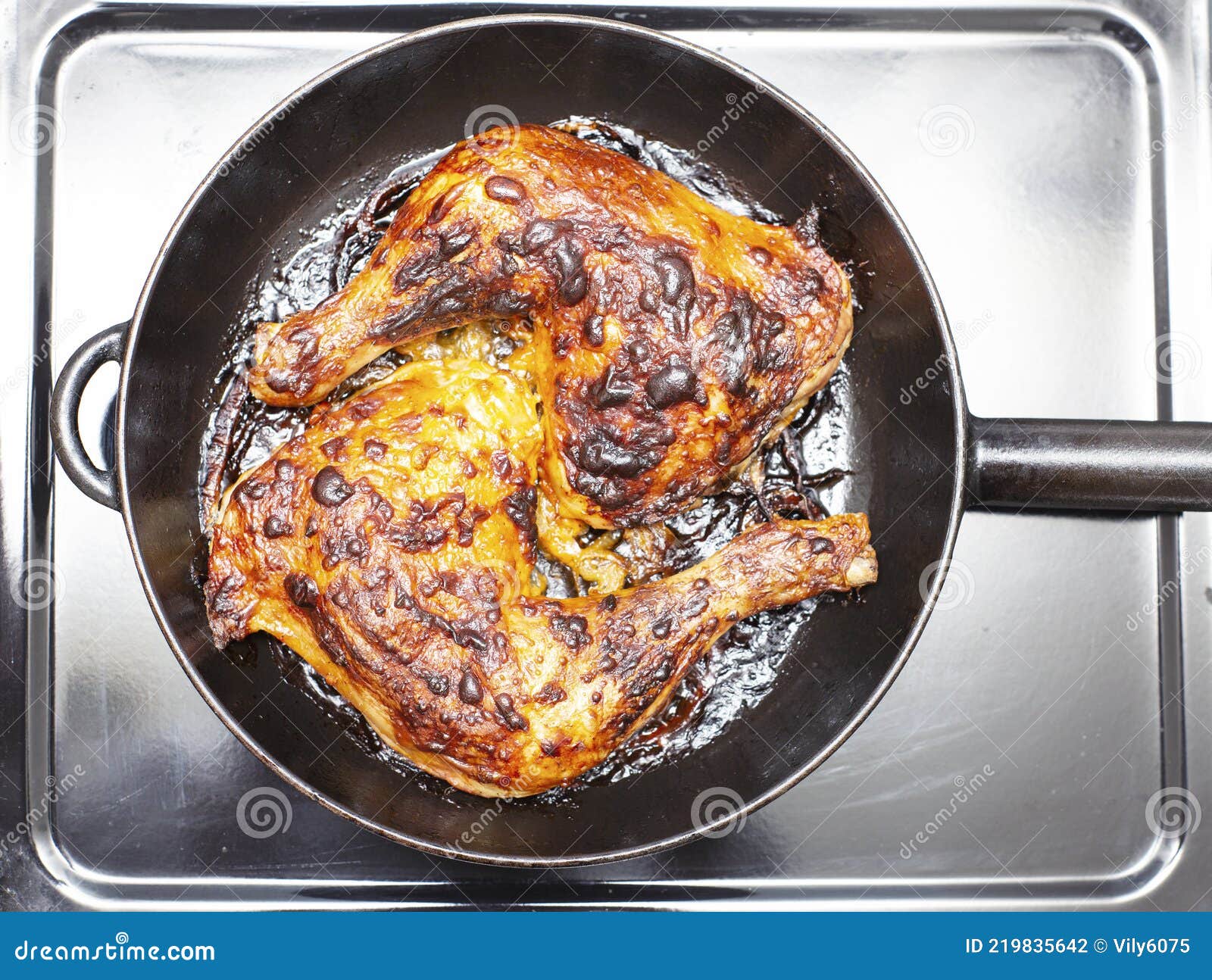 Top View of Fried, Chicken Drumsticks on Cast Iron Pan Stock Photo