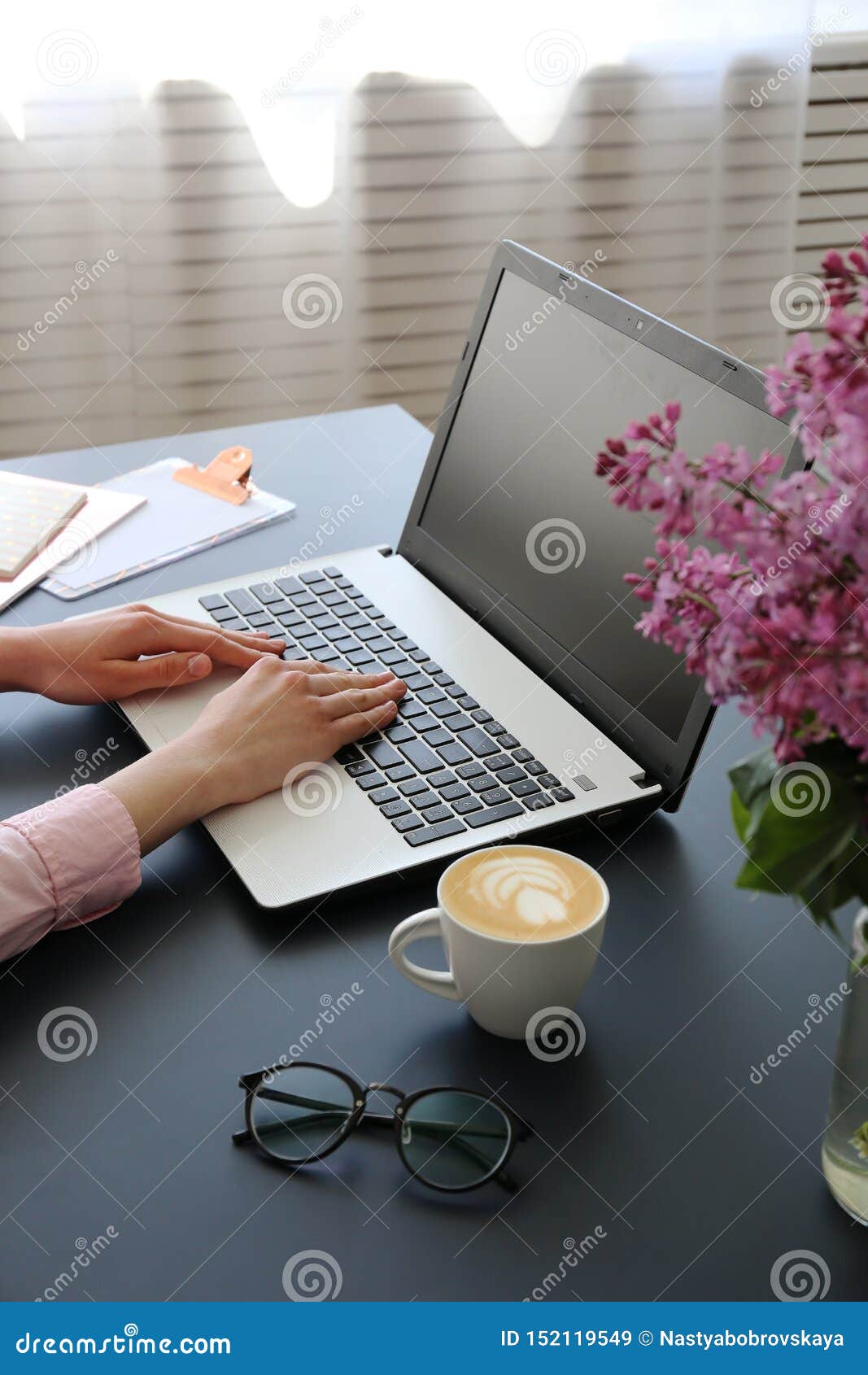 top view of frmale hands on laptop keyboard