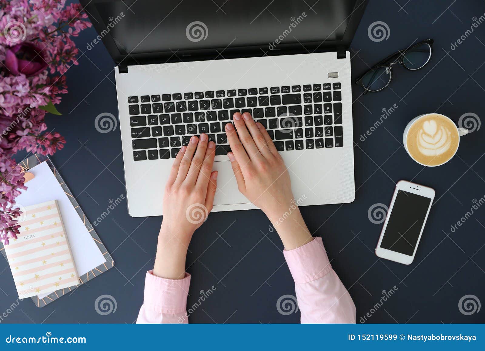 top view of frmale hands on laptop keyboard