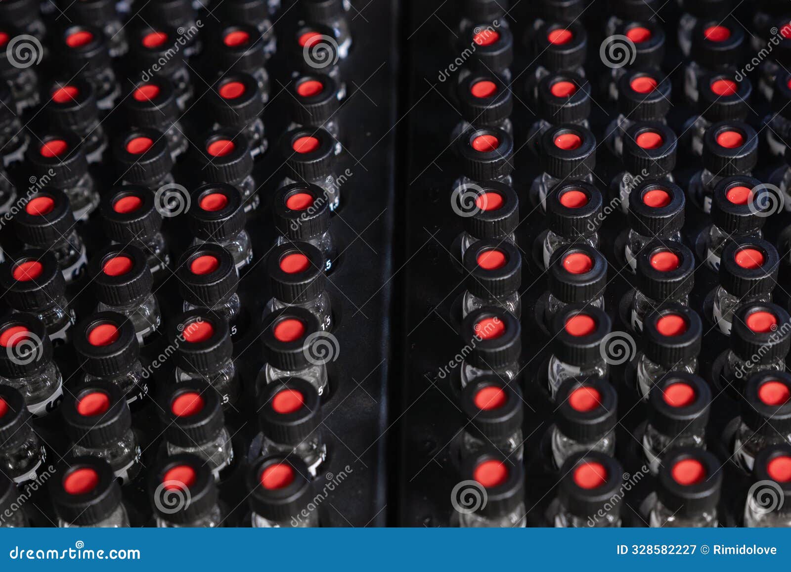 top view of glass hplc vials with black caps in autosampler