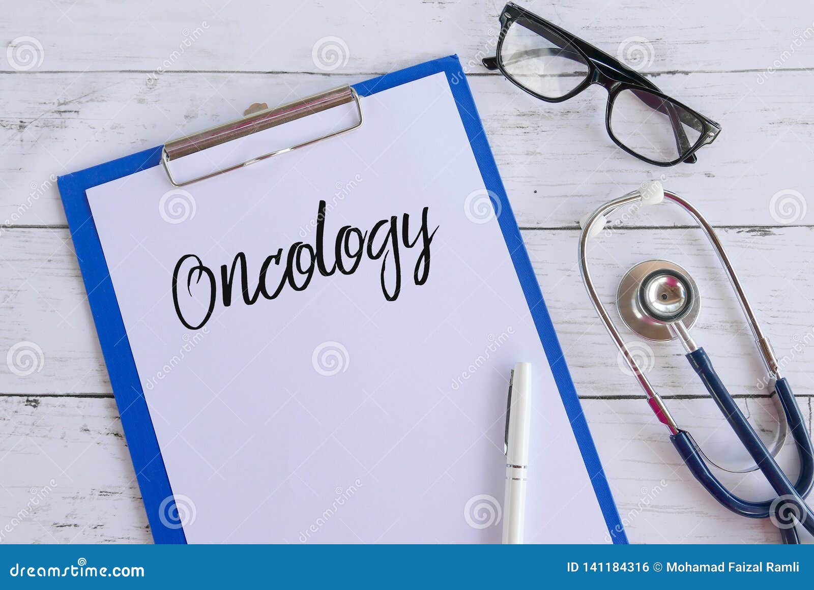 top view of glasses,stethoscope,pen,clipboard and paper written with oncology. healthcare and medical concept.