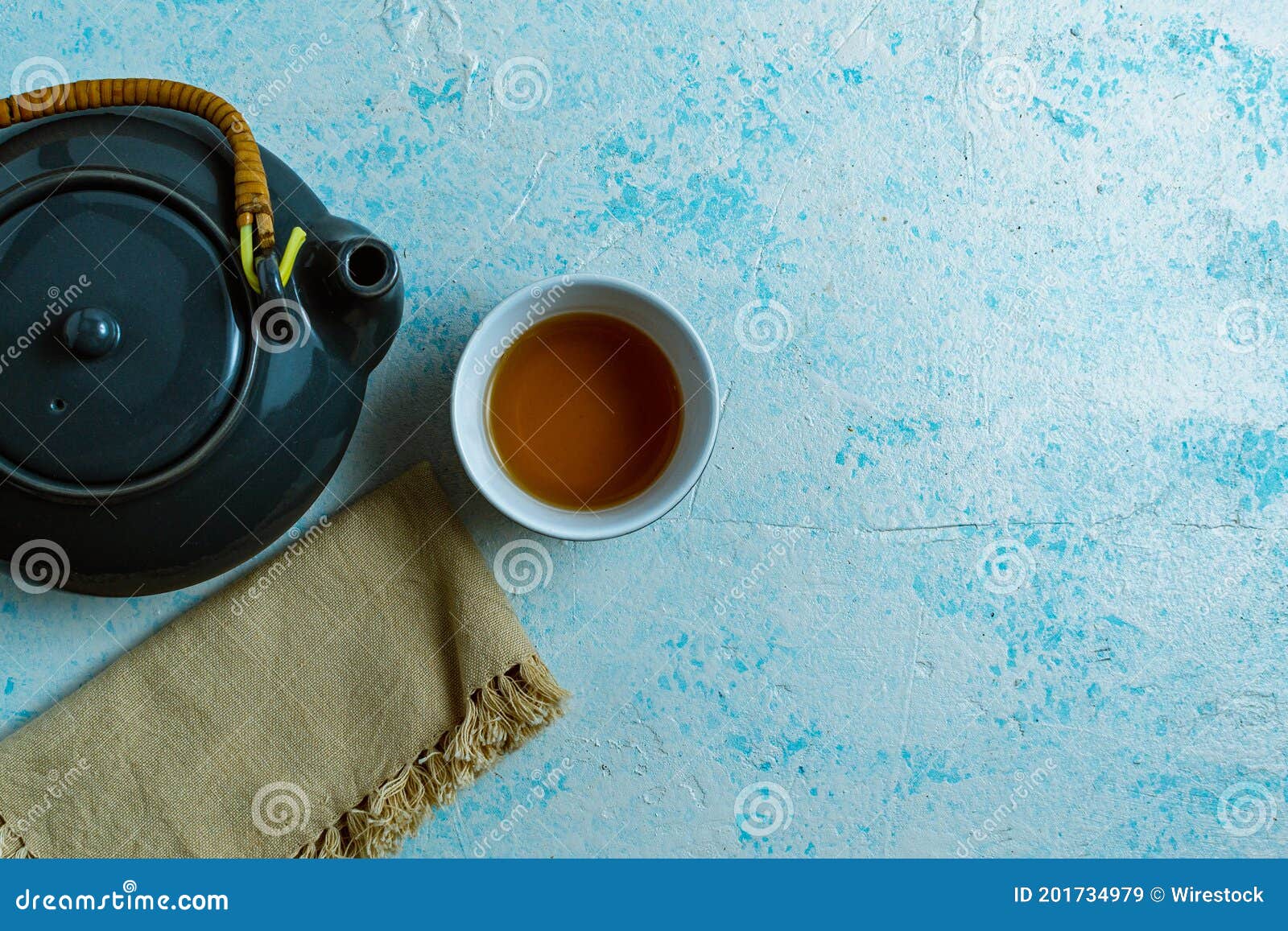 Top View of a Gray Teapot and a Cup on Blue Background Stock Image