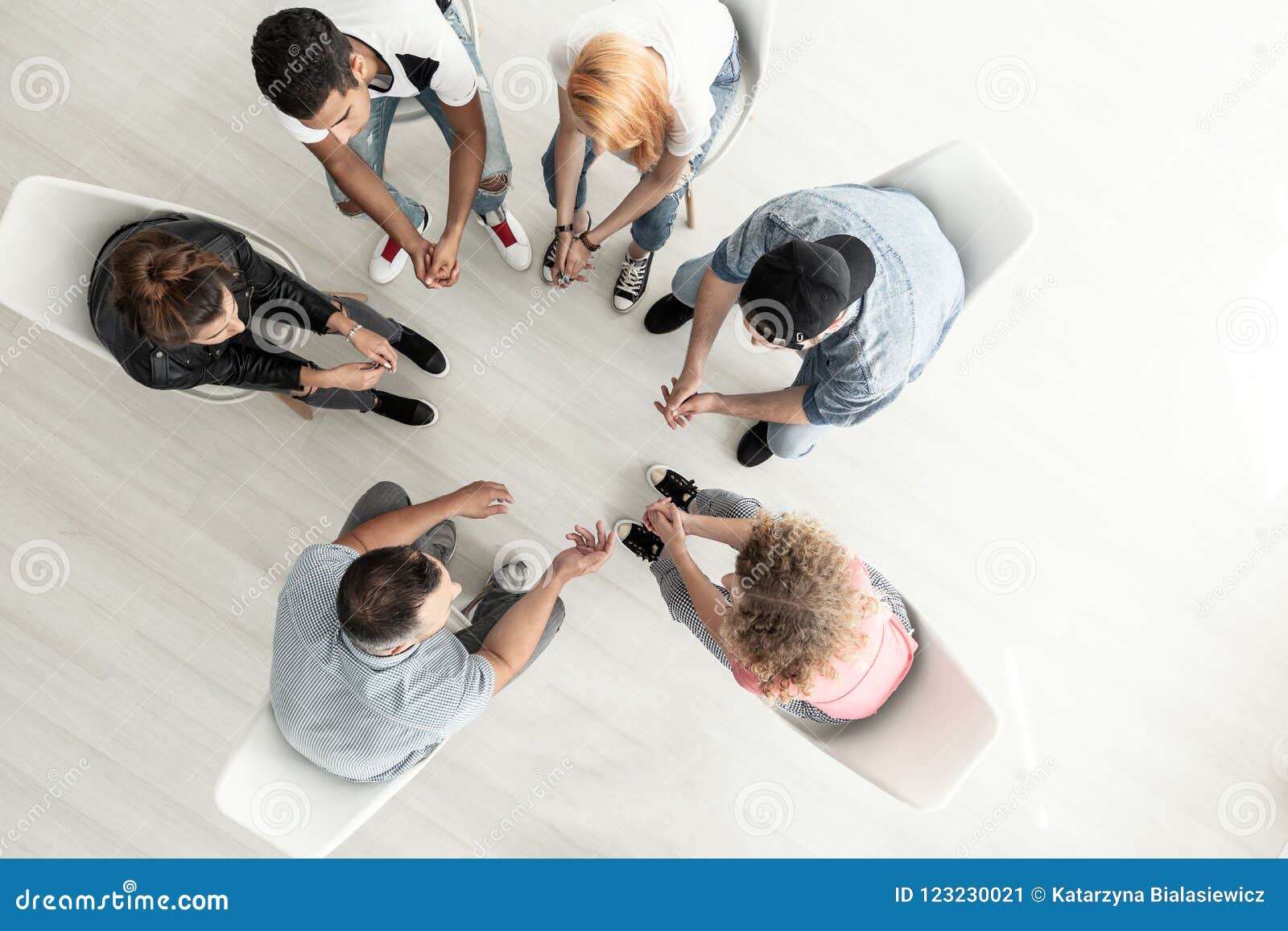 top view on group of teenagers sitting in a circle during consul