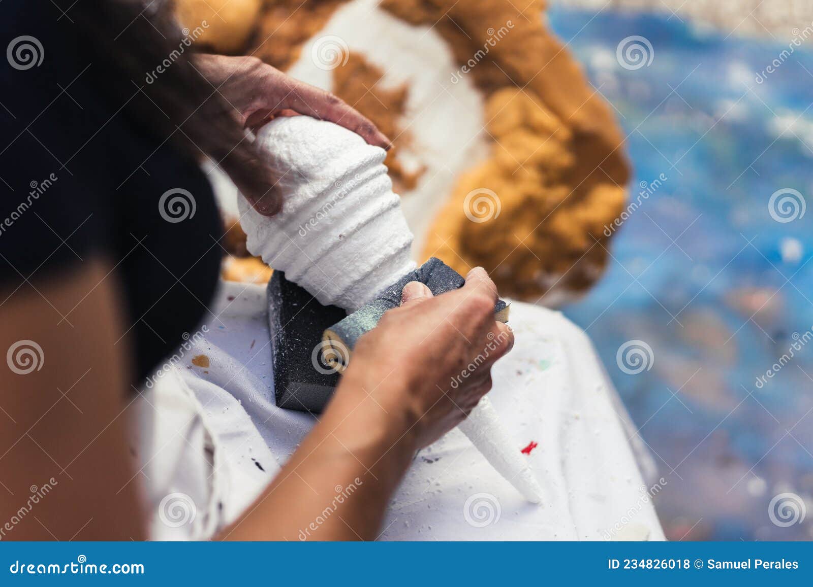 Hands of a Woman Polishing a Piece of Polystyrene in a Stock