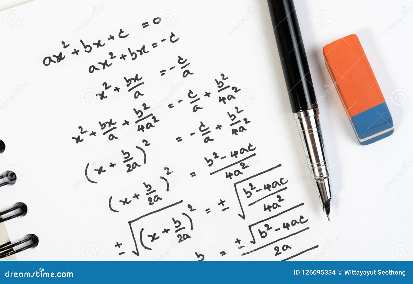 top view of handwriting of mathematics quadratic equation formula on examination, practice, quiz or test in math class.