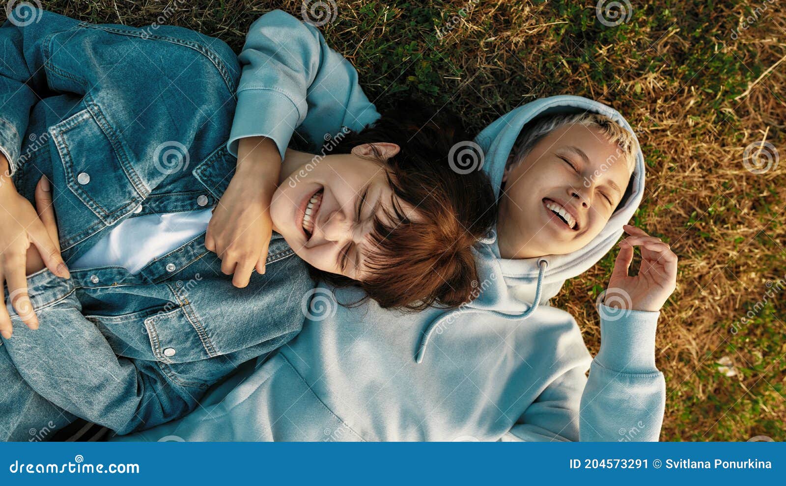 Top View Of Happy Lesbian Couple Lying On The Grass In Summer Park Girls In Love Laughing While