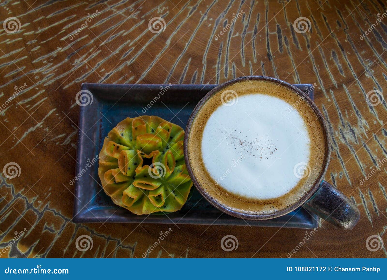 top view of hot coffee cappuccino cup served with thai sweetmeat