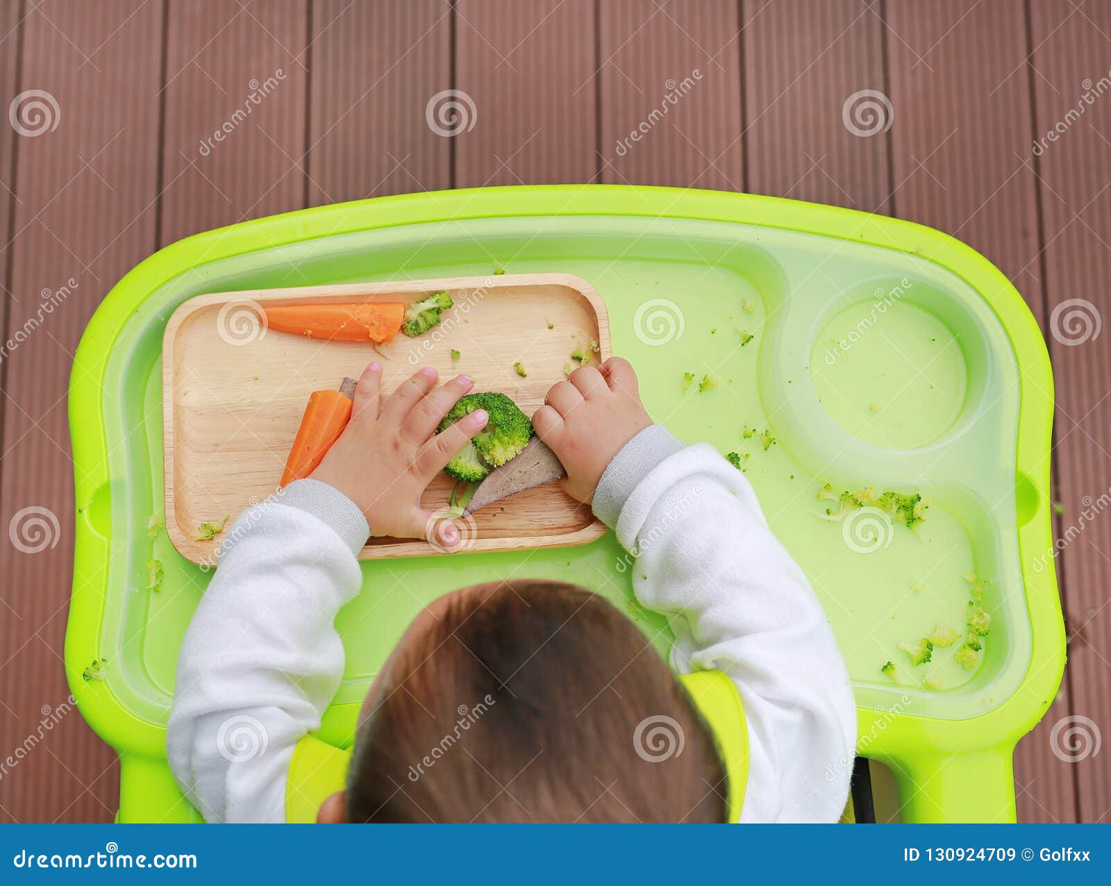 Top View of Infant Baby Eating by Baby Led Weaning BLW. Finger Foods