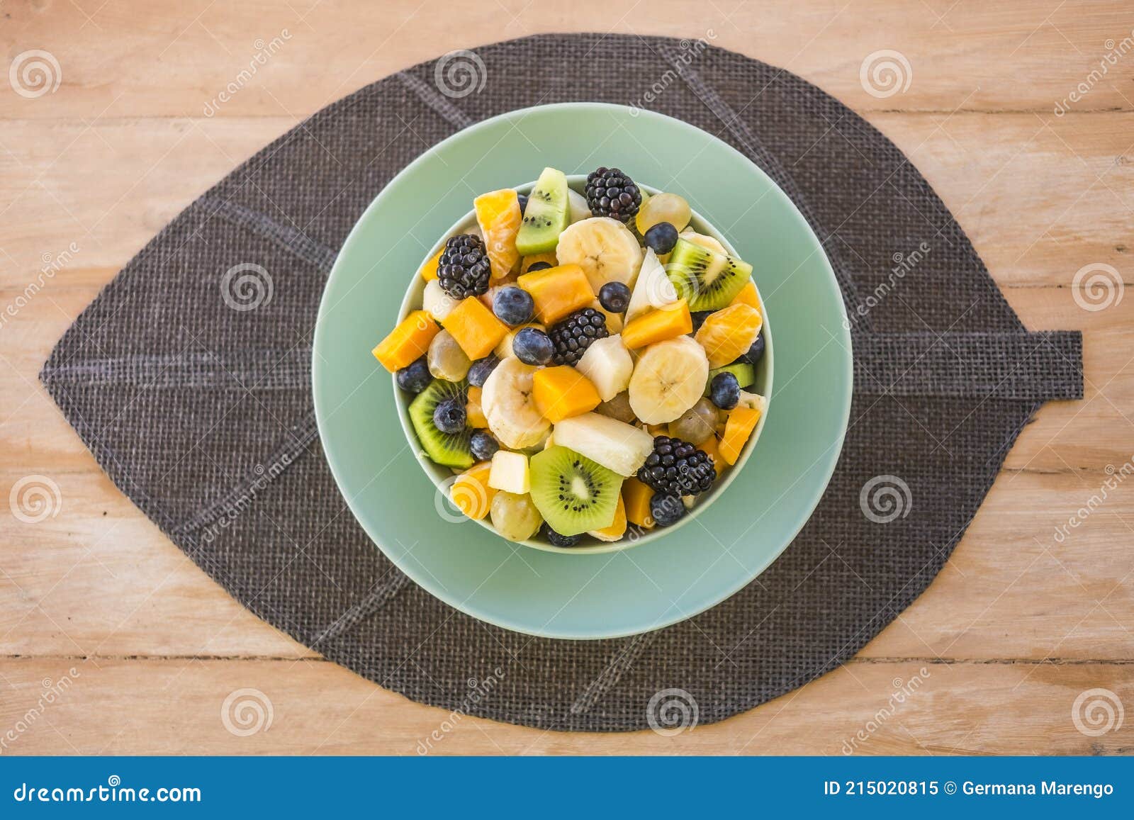 Close up view of a wooden table with a fresh, ready-to-eat homemade  vegetable soup. Stock Photo by lucigerma