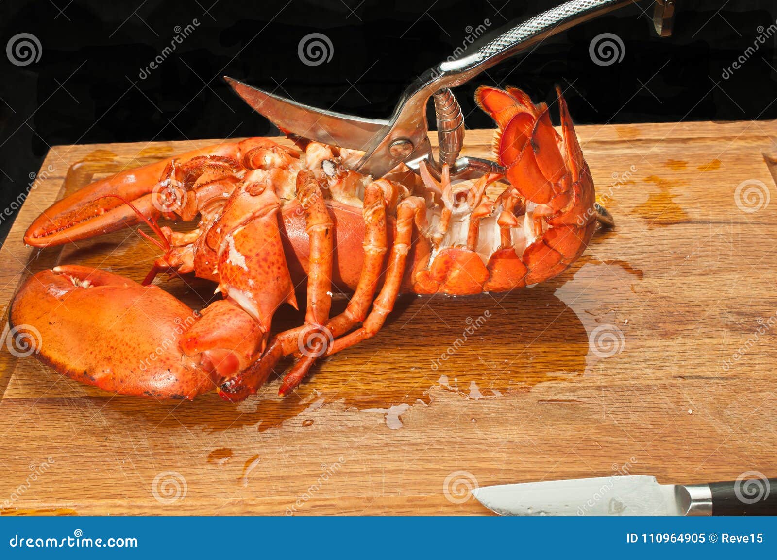 large steamed lobster being cut open