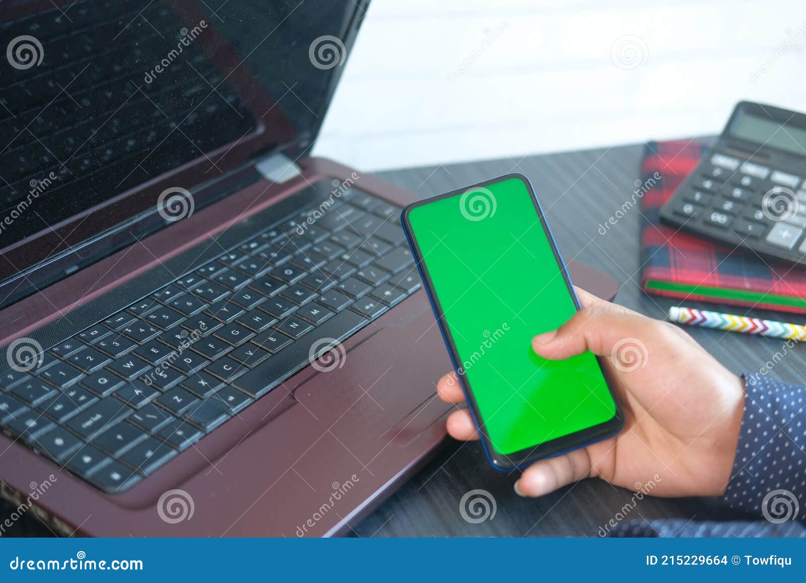top view of man hand using smart phone on office desk