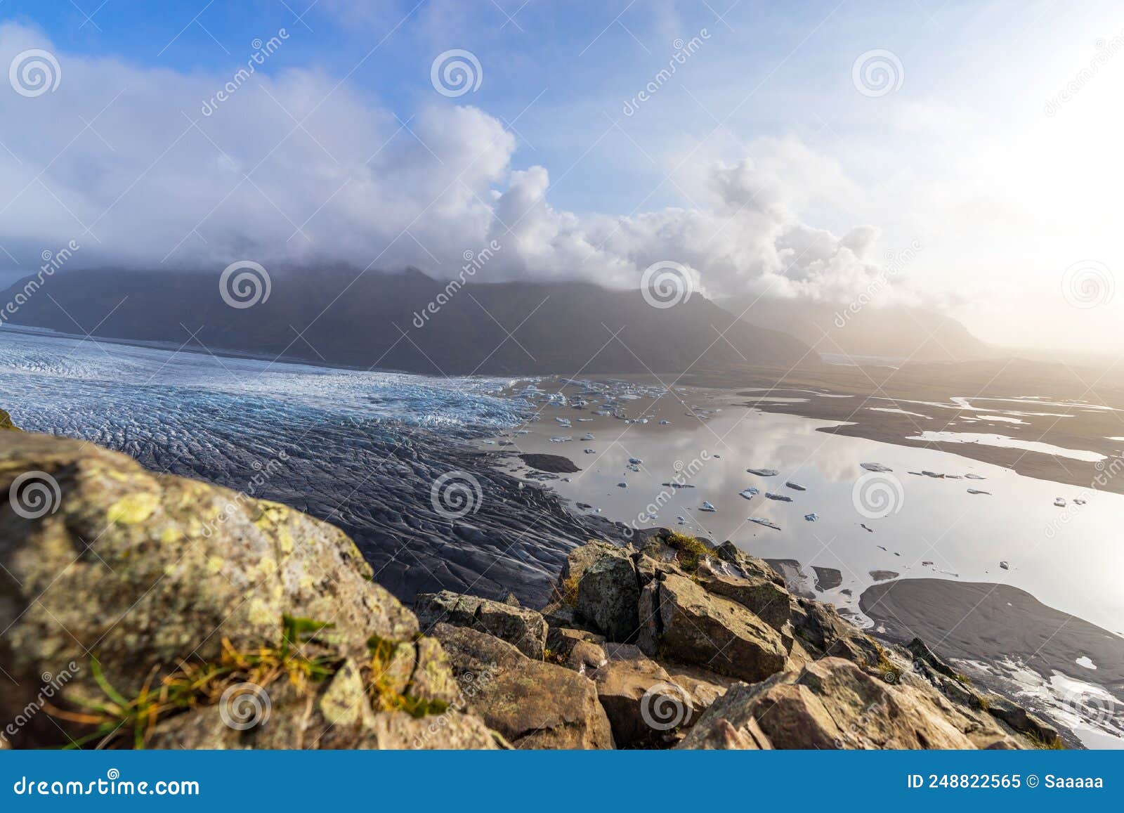 top view of massive glacier with clouds and ray lights