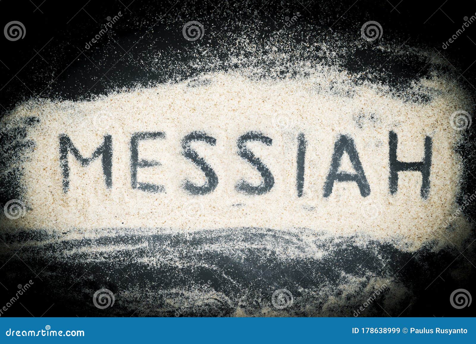 top view of messiah word written on sand