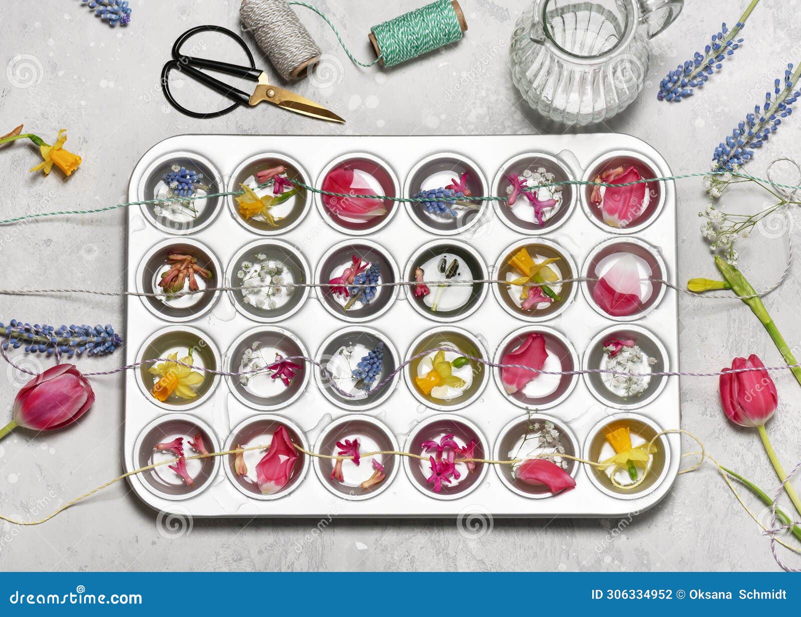 top view of muffin tin with different flowers, petals and strings init.