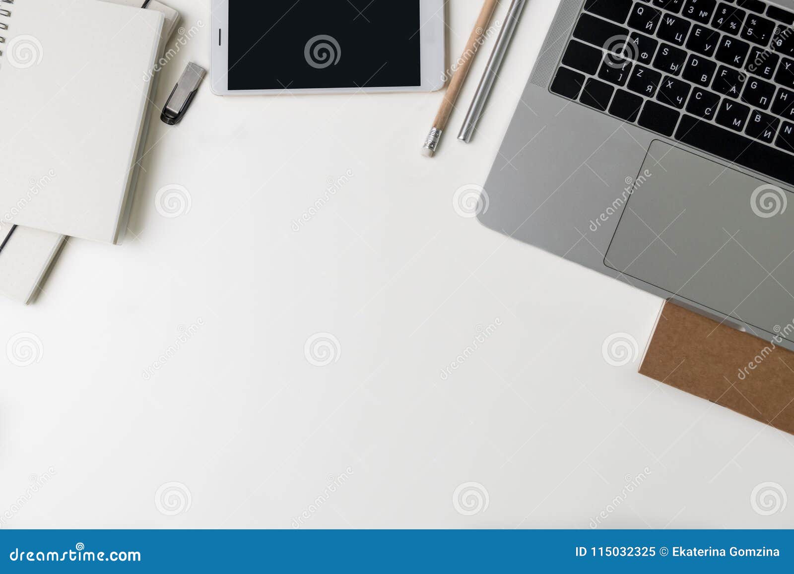 top view of office workplace. white desk with copy space. flat lay view on table with laptop, pen, pencil, phone, notebooks