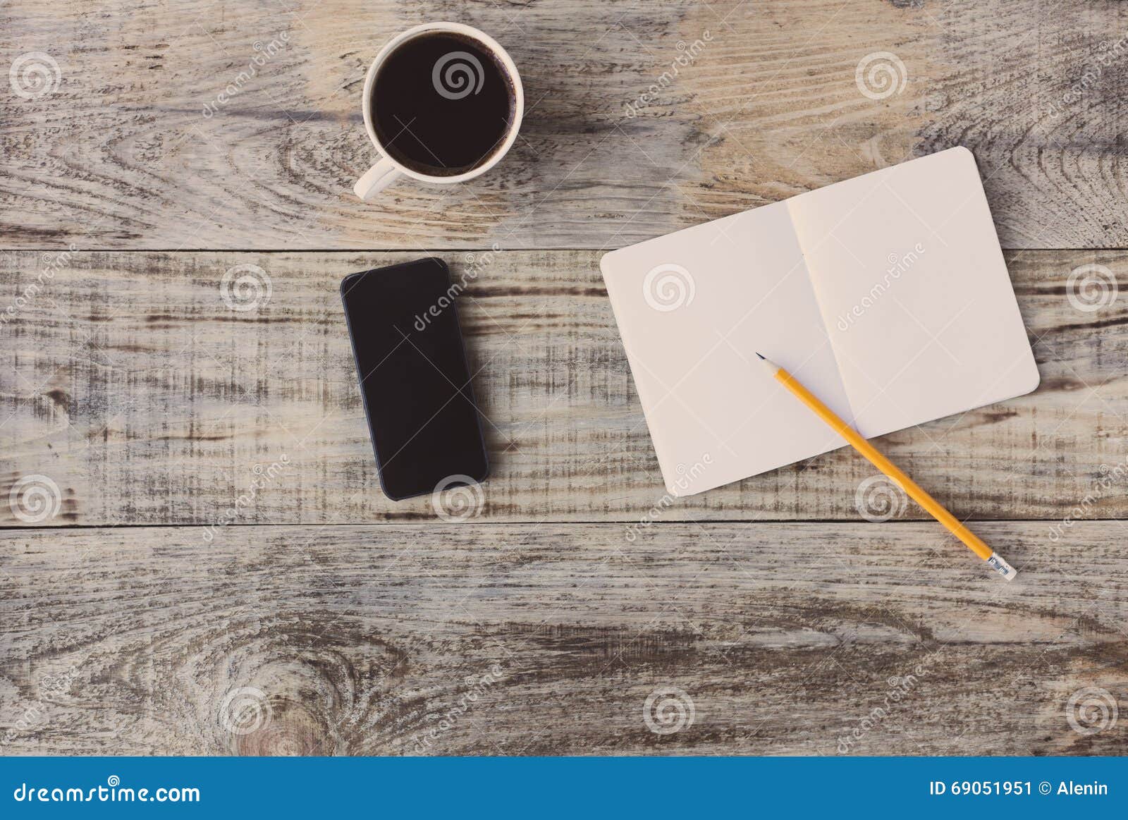 top view on opened notebook, smartphone, highlighters, and other equipment on wooden office desk, old plancs. hipster style