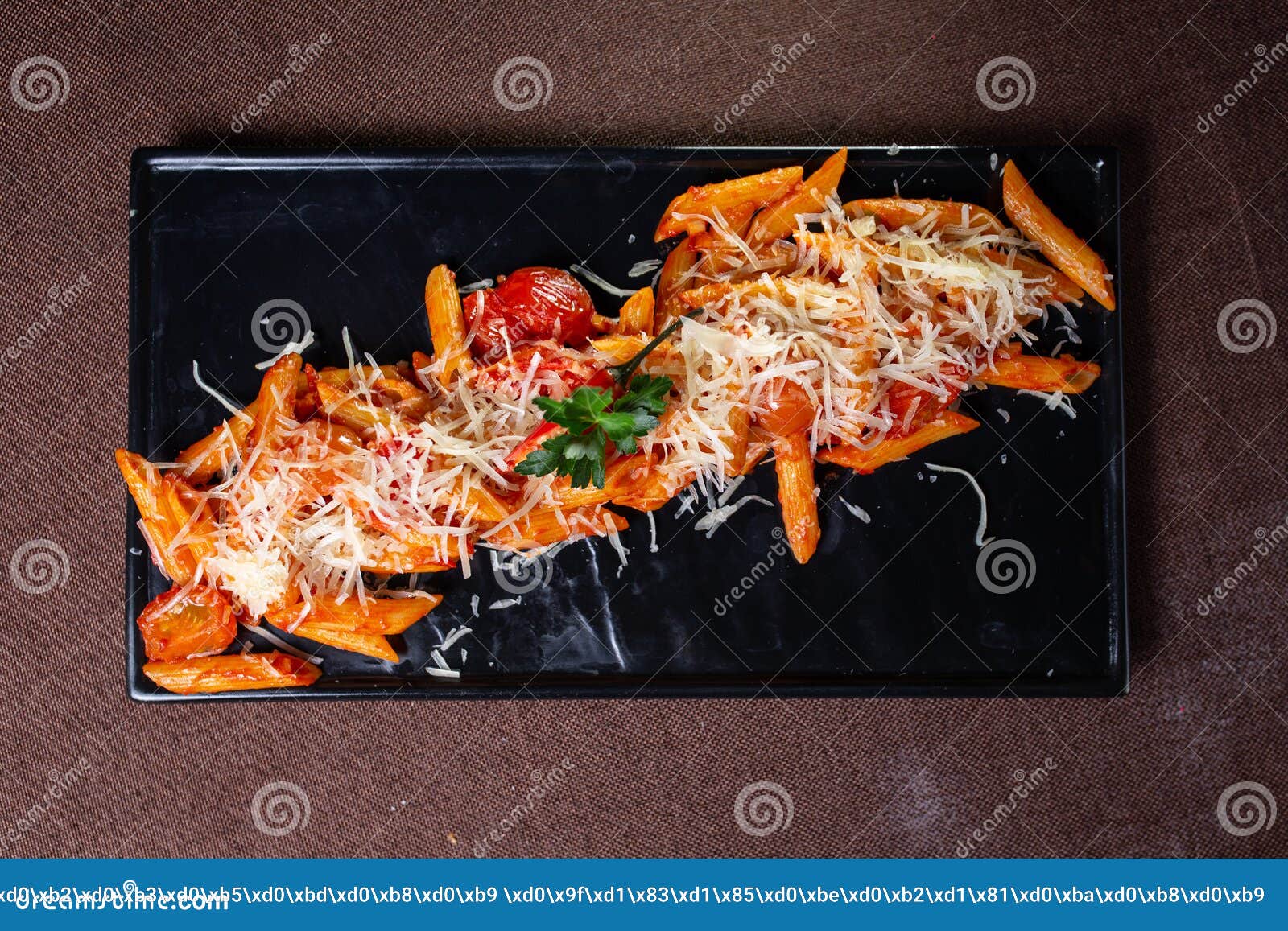 Top View Pasta with Cheese and Stewed Tomatoes on a Black Plate Stock