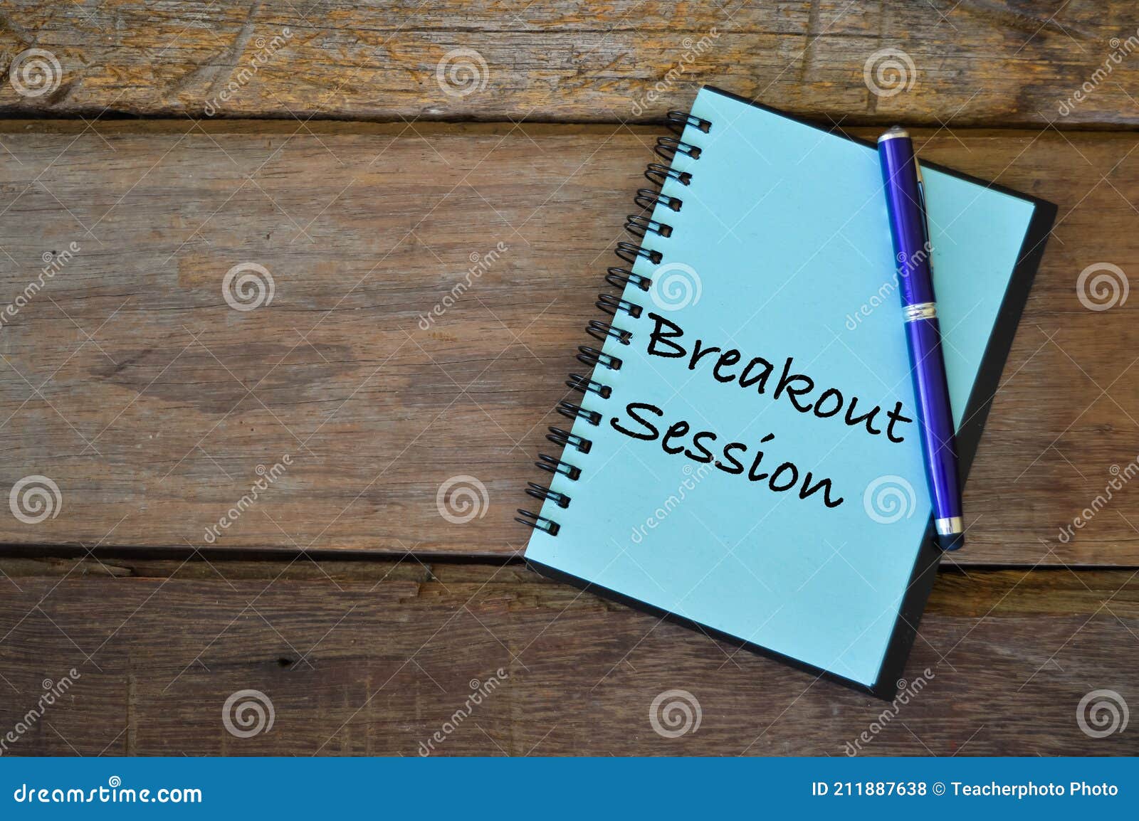 notebook written with text breakout session over wooden background