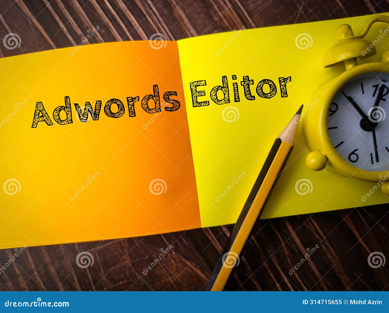 top view pencil,clock and colored notepaper with text adwords editor