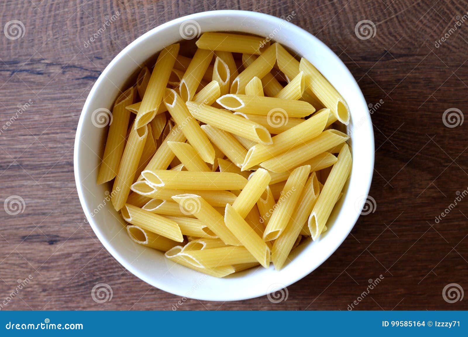 Penne pasta in a bowl stock photo. Image of bowl, italian 99585164