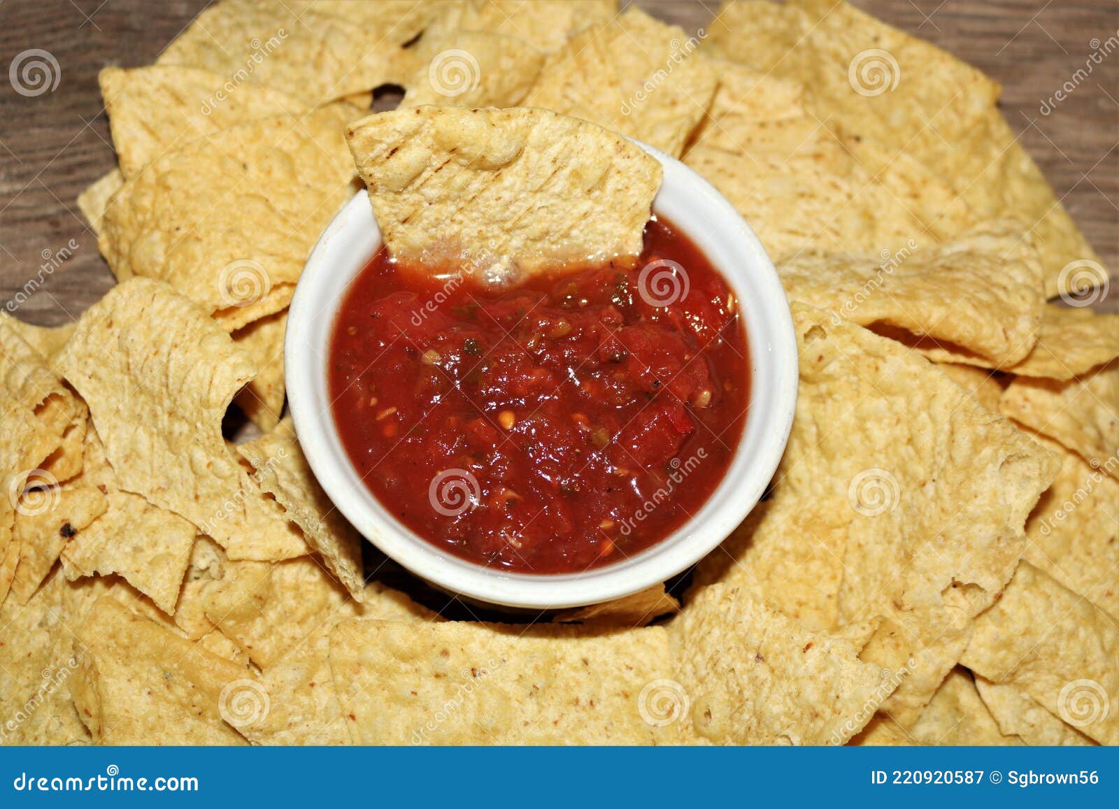 picante sauce in white bowl surrounded with tortilla chips