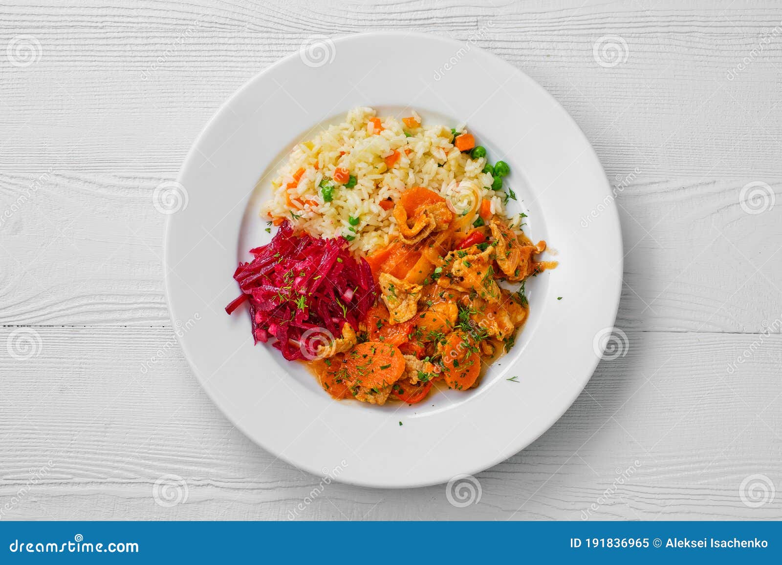 Top View of Plate with Beef Goulash, Rice with Peas and Beetroot Salad