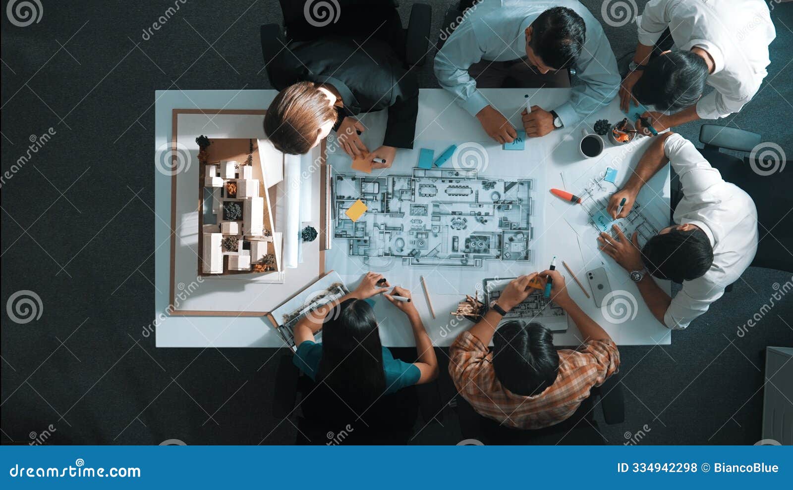 top view of project manager or engineer writing at blueprint. alimentation.