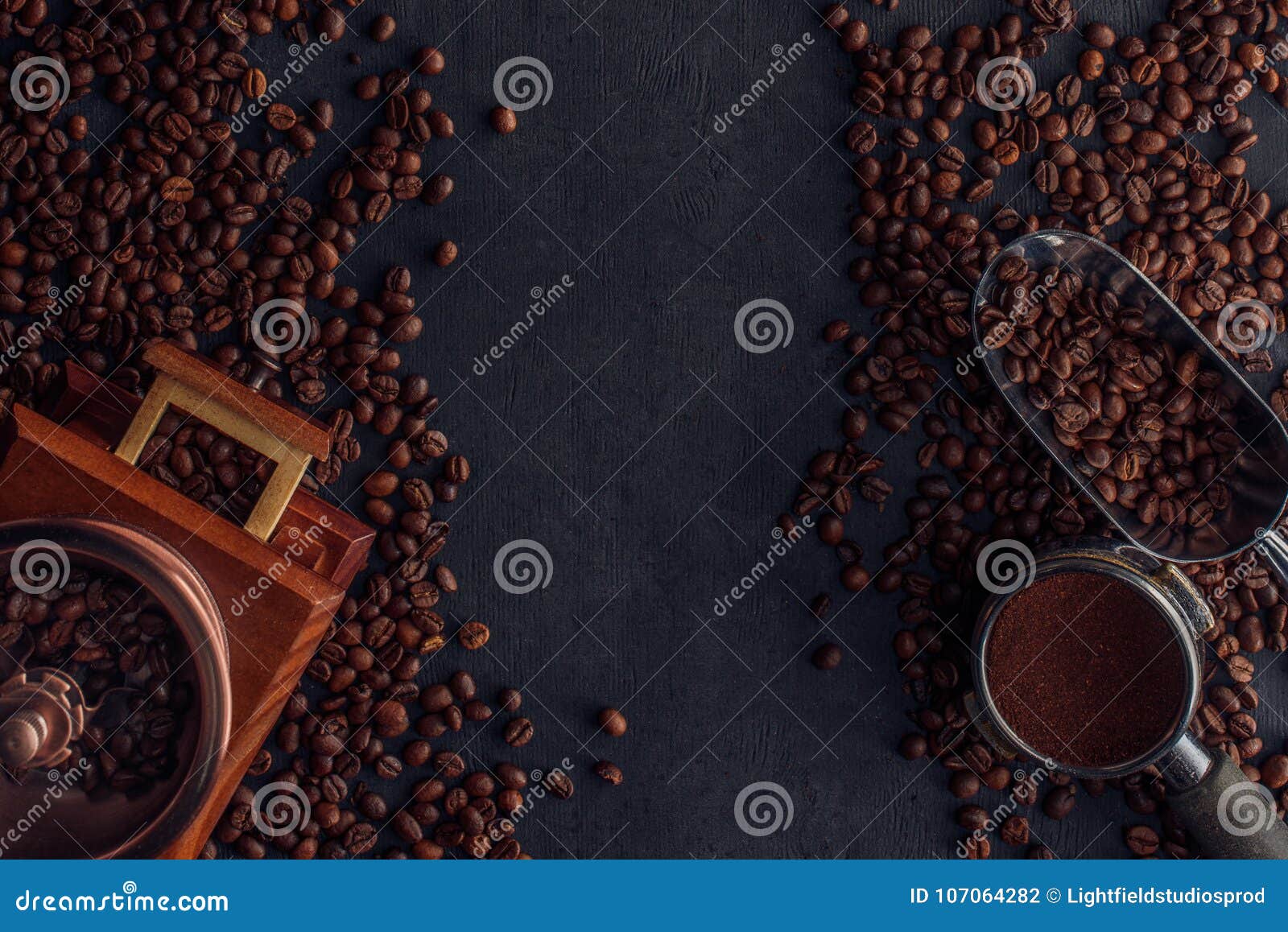 Top View of Roasted Coffee Beans, Coffee Grinder and Scoop Stock Photo