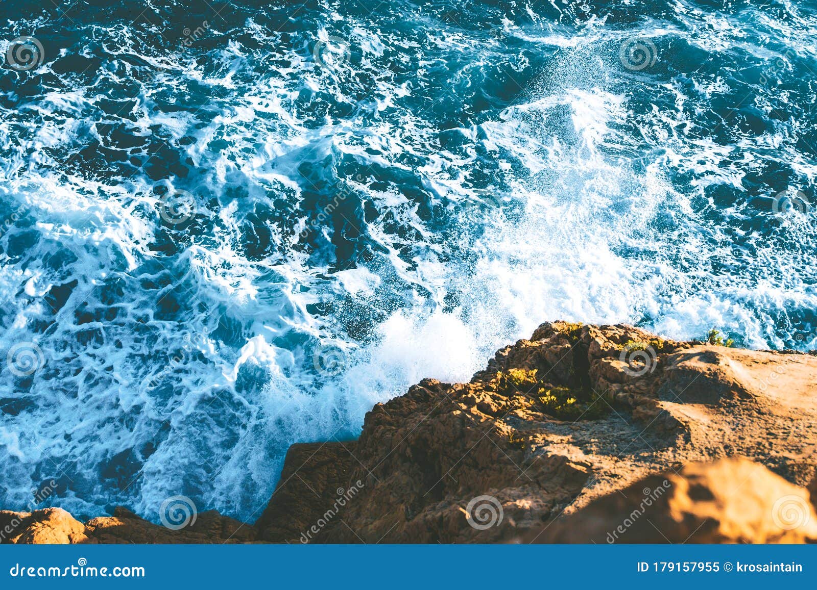 Top View Of Sea Waves Hitting Rocks On The Beach With Turquoise Blue