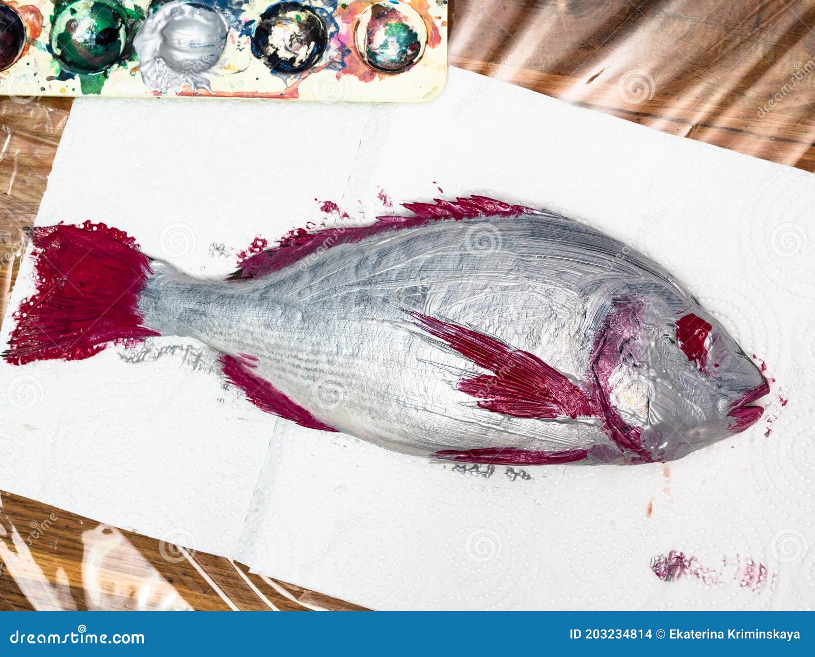 top view of silver colored orata fish on paper