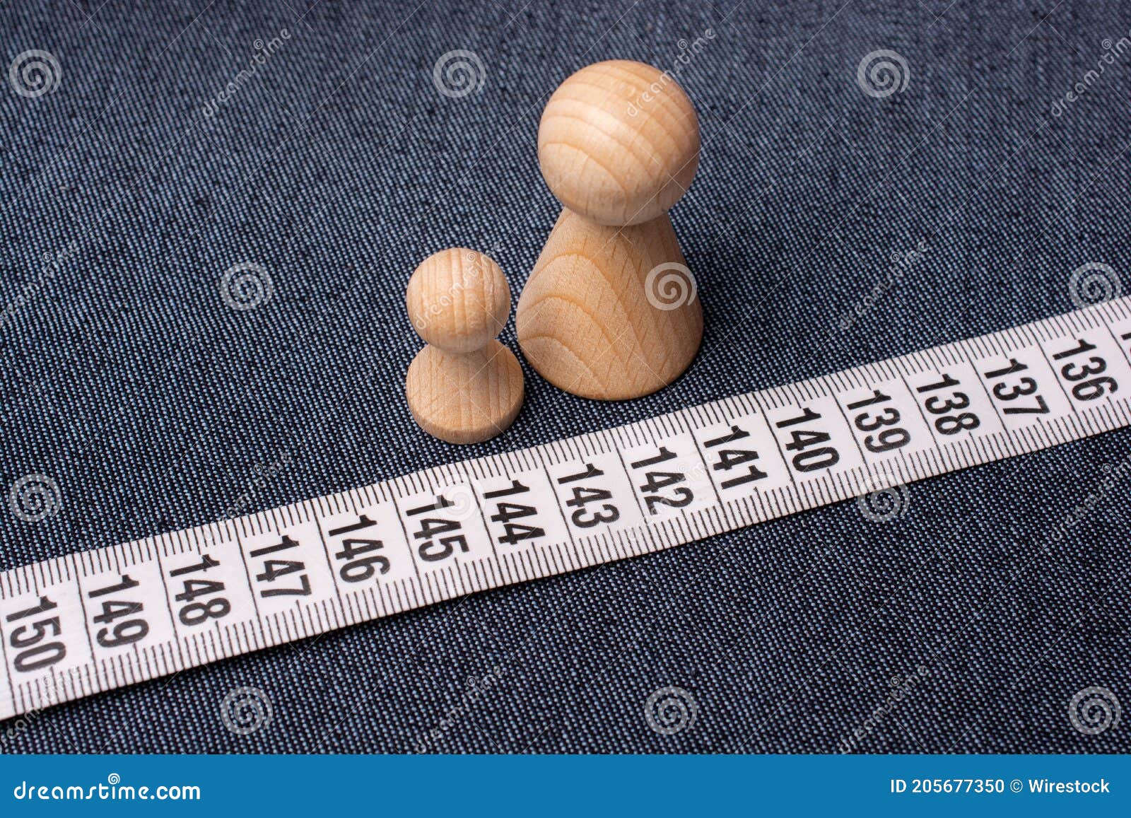 https://thumbs.dreamstime.com/z/top-view-soft-tailor-tape-measure-jeans-material-small-wooden-figurines-top-view-soft-tailor-tape-205677350.jpg