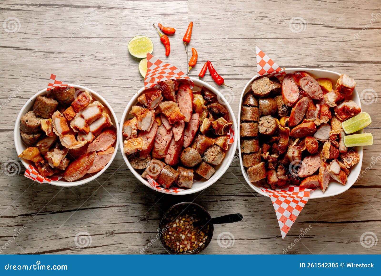 Top View of Three Bowls of Different Sliced Meats and a Bowl of