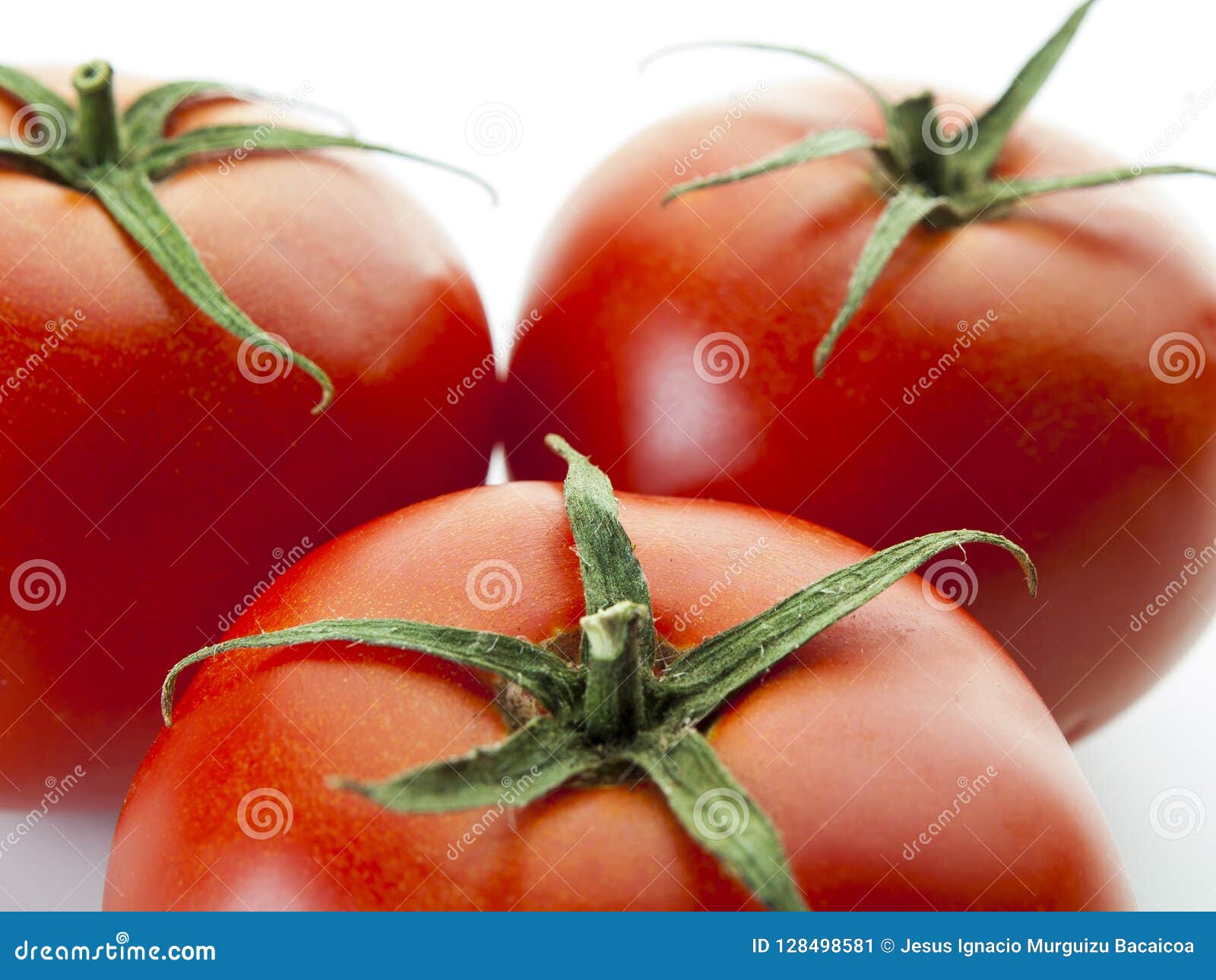 top view of three red tomatoes on a white background