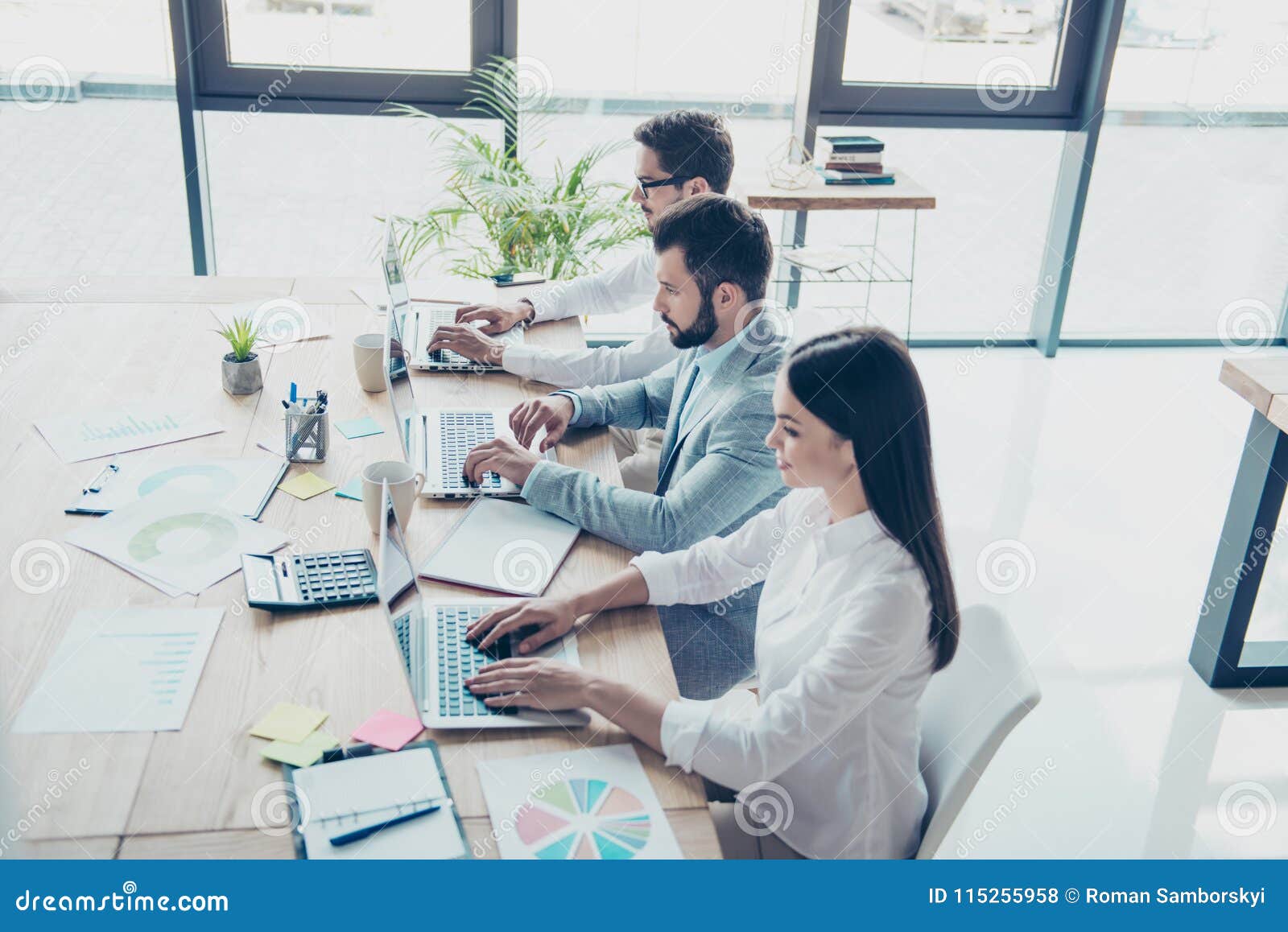Top View of Three White Collars Sitting and Working in the Office. they