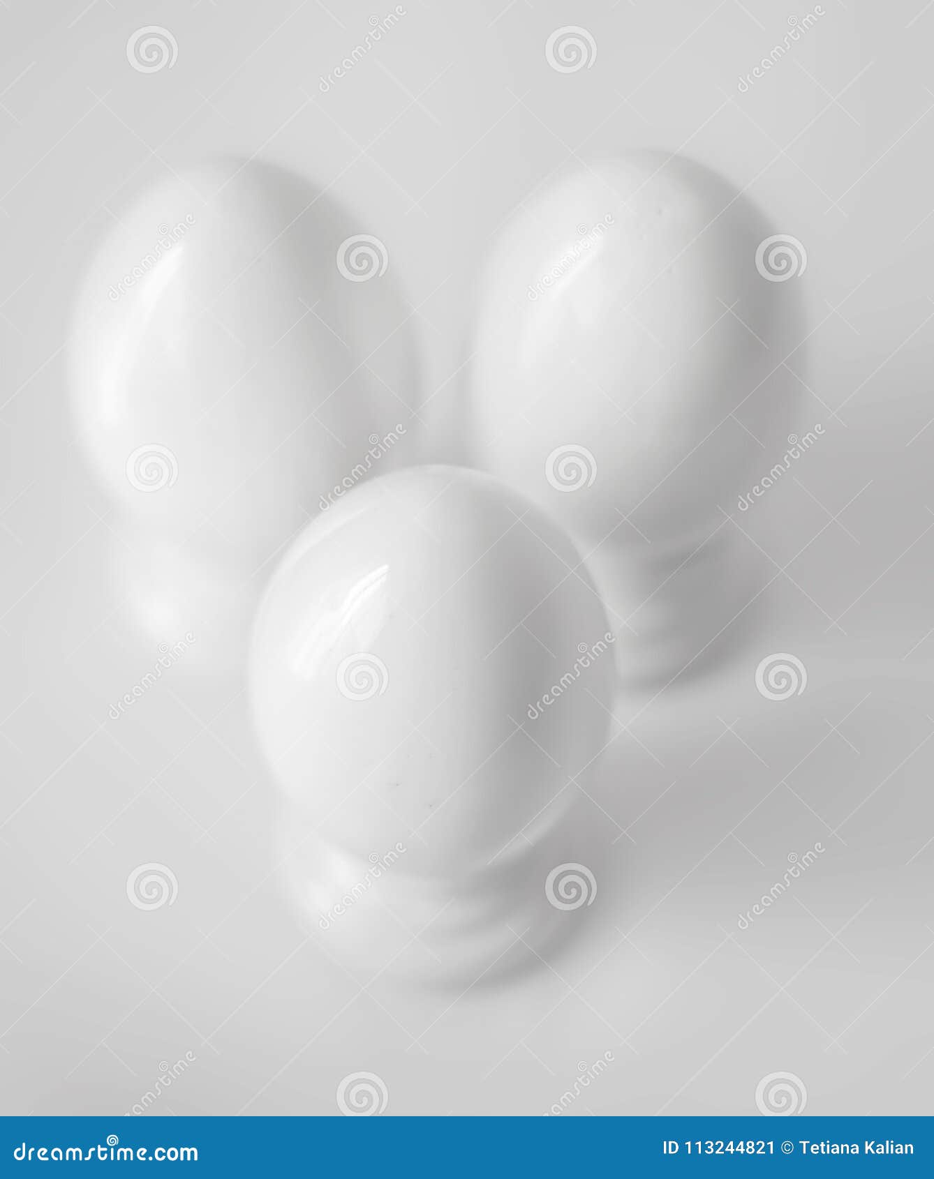 Top View Of Three White Decorative Ceramic Eggs On Stands Or In