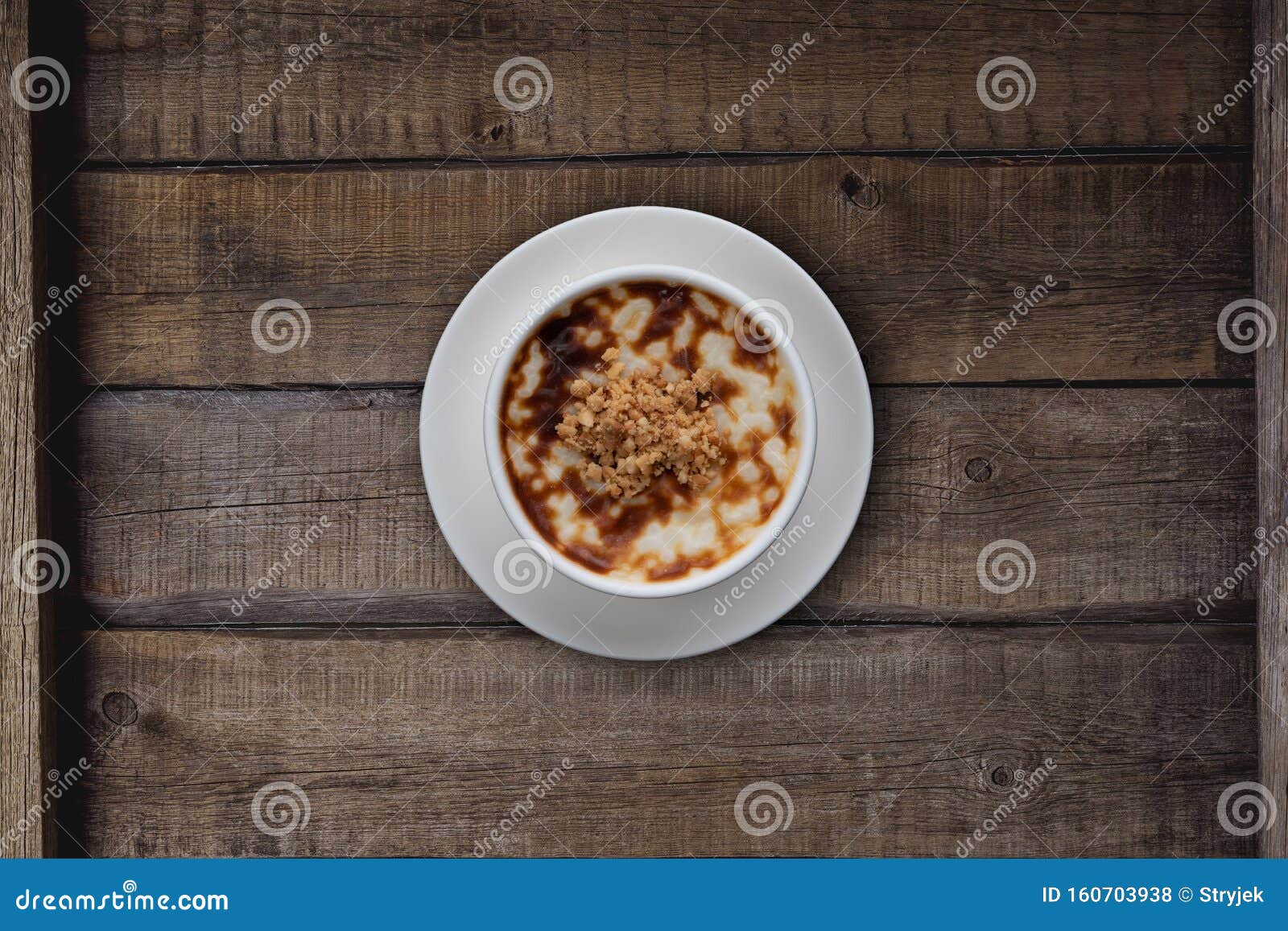 top view of traditional tukish rice pudding with walnut on rustic wooden table