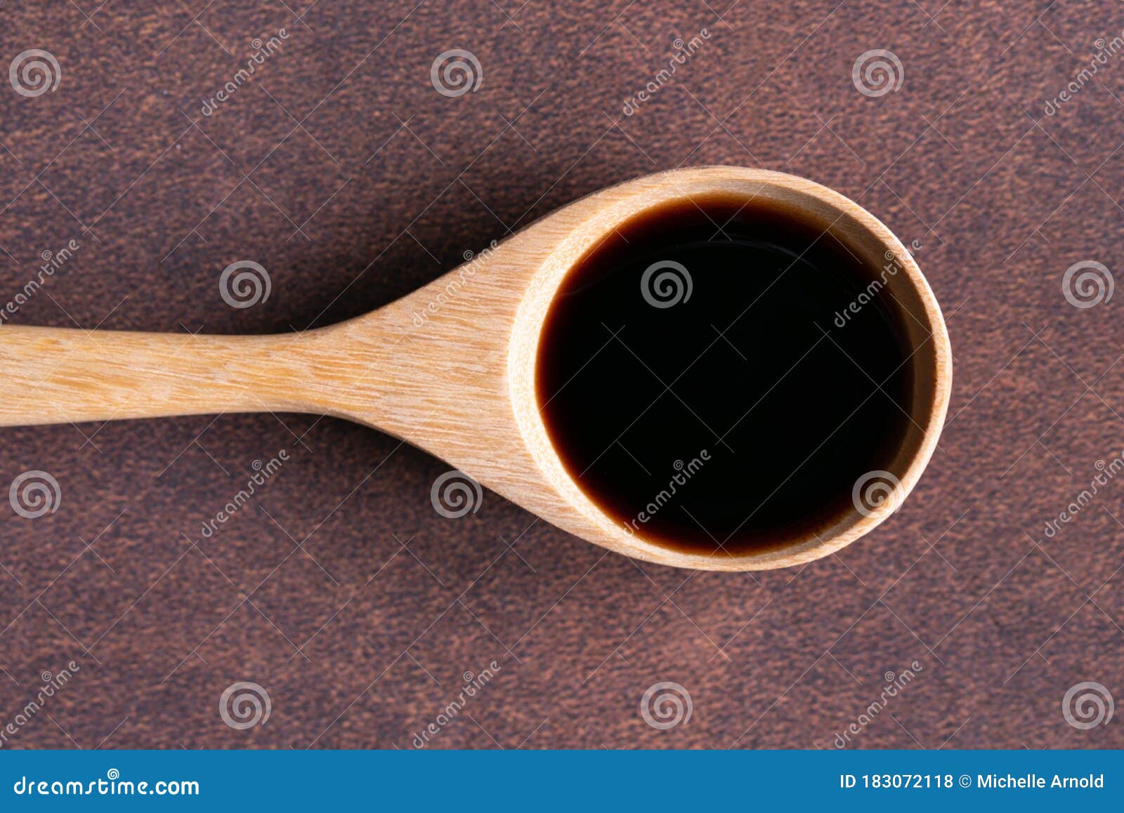 vanilla extract on a wood spoon